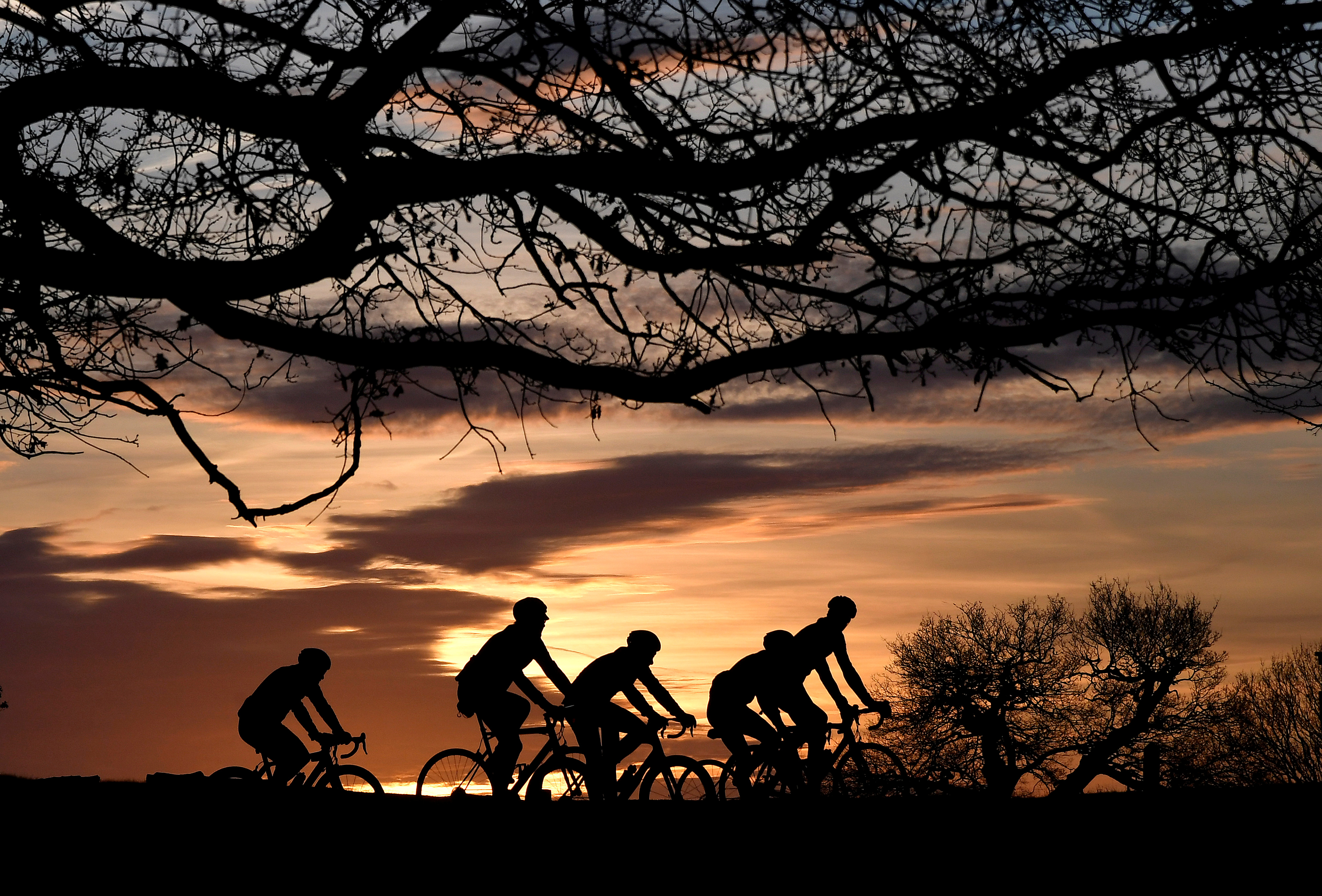 Cyclists ride at sunrise in London
