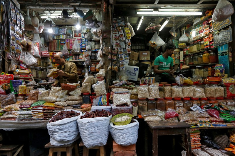 Vendors wait for customers at their respective shops at a retail market in Kolkata