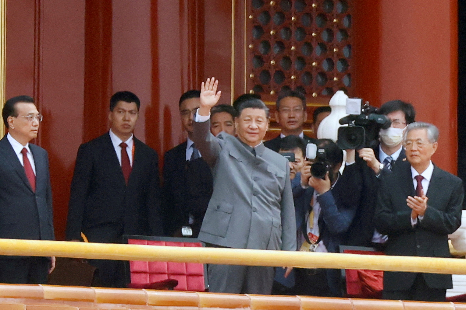Chinese President Xi Jinping waves next to Premier Li Keqiang and former president Hu Jintao at the end of the event marking the 100th founding anniversary of the Communist Party of China, on Tiananmen Square in Beijing, China July 1, 2021. REUTERS/Carlos Garcia Rawlins/File Photo