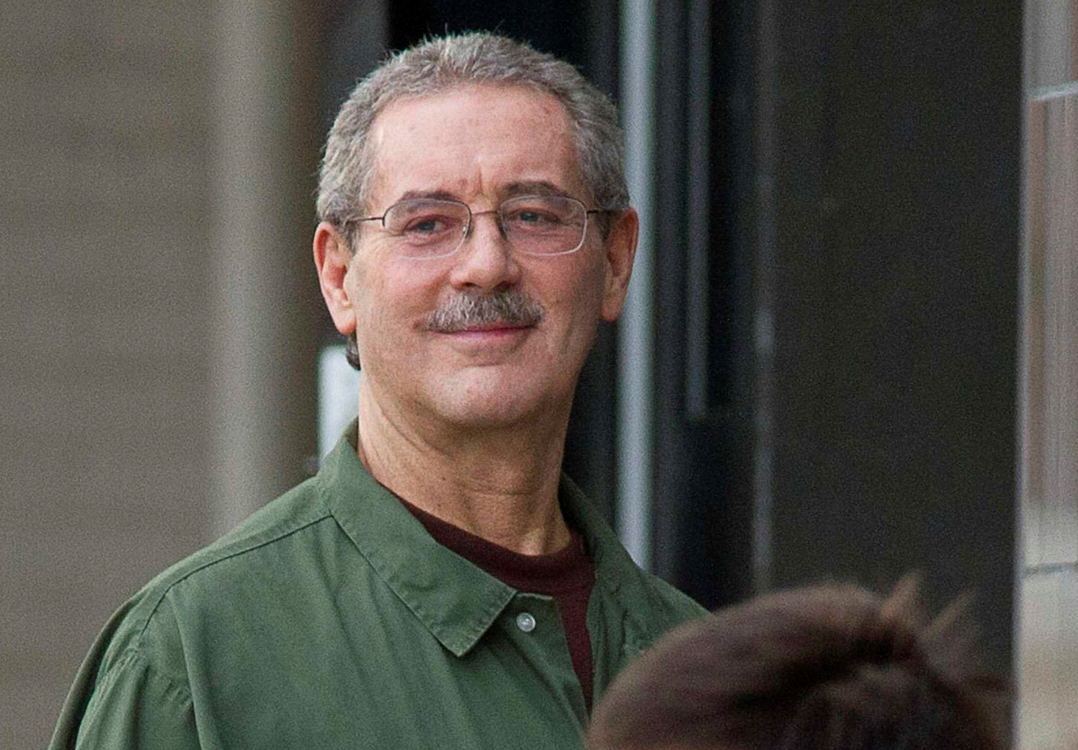 Allen Stanford smiles as he waits to enter the Federal Courthouse in Houston