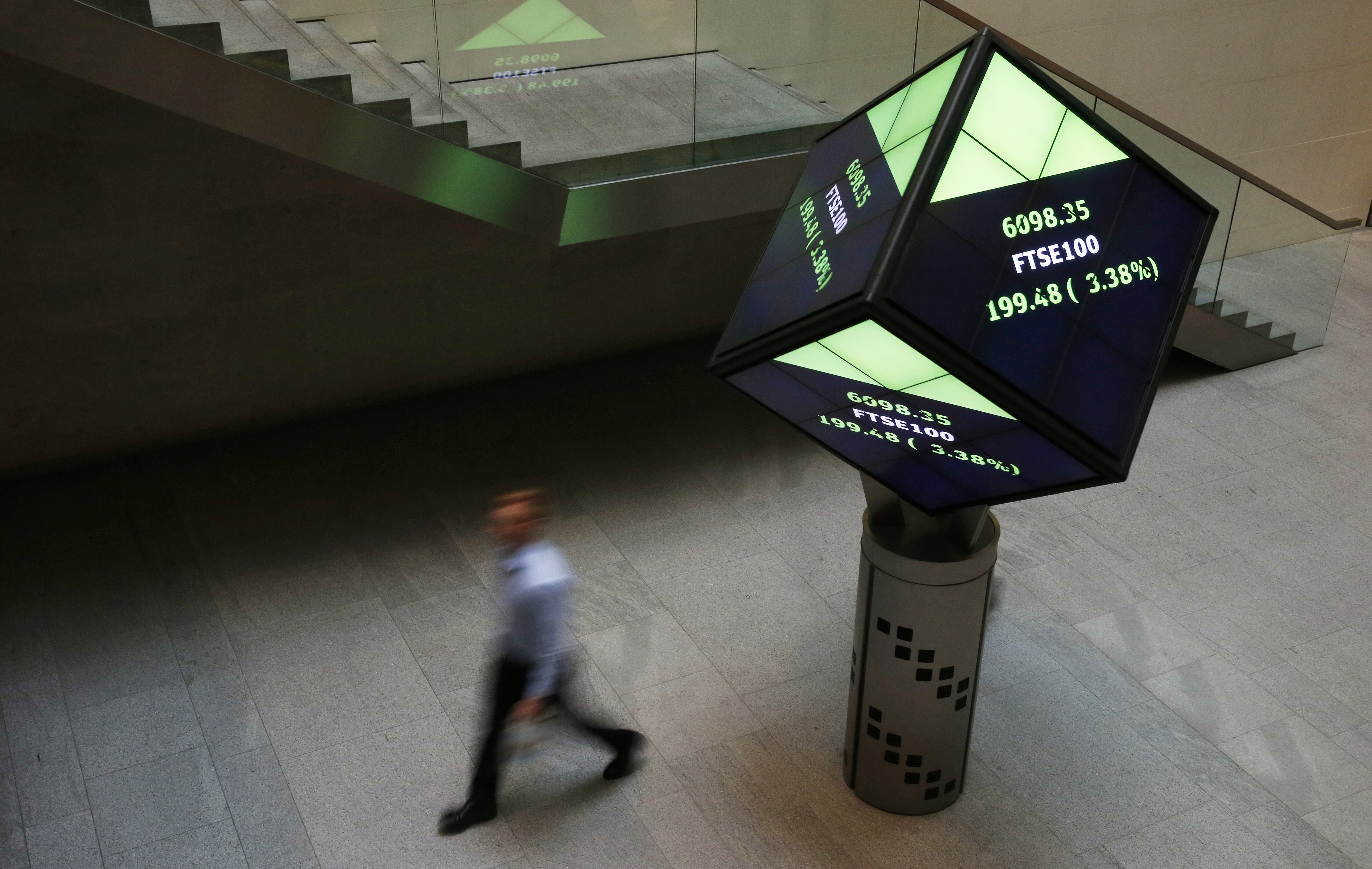 A man walks through the lobby of the London Stock Exchange in London