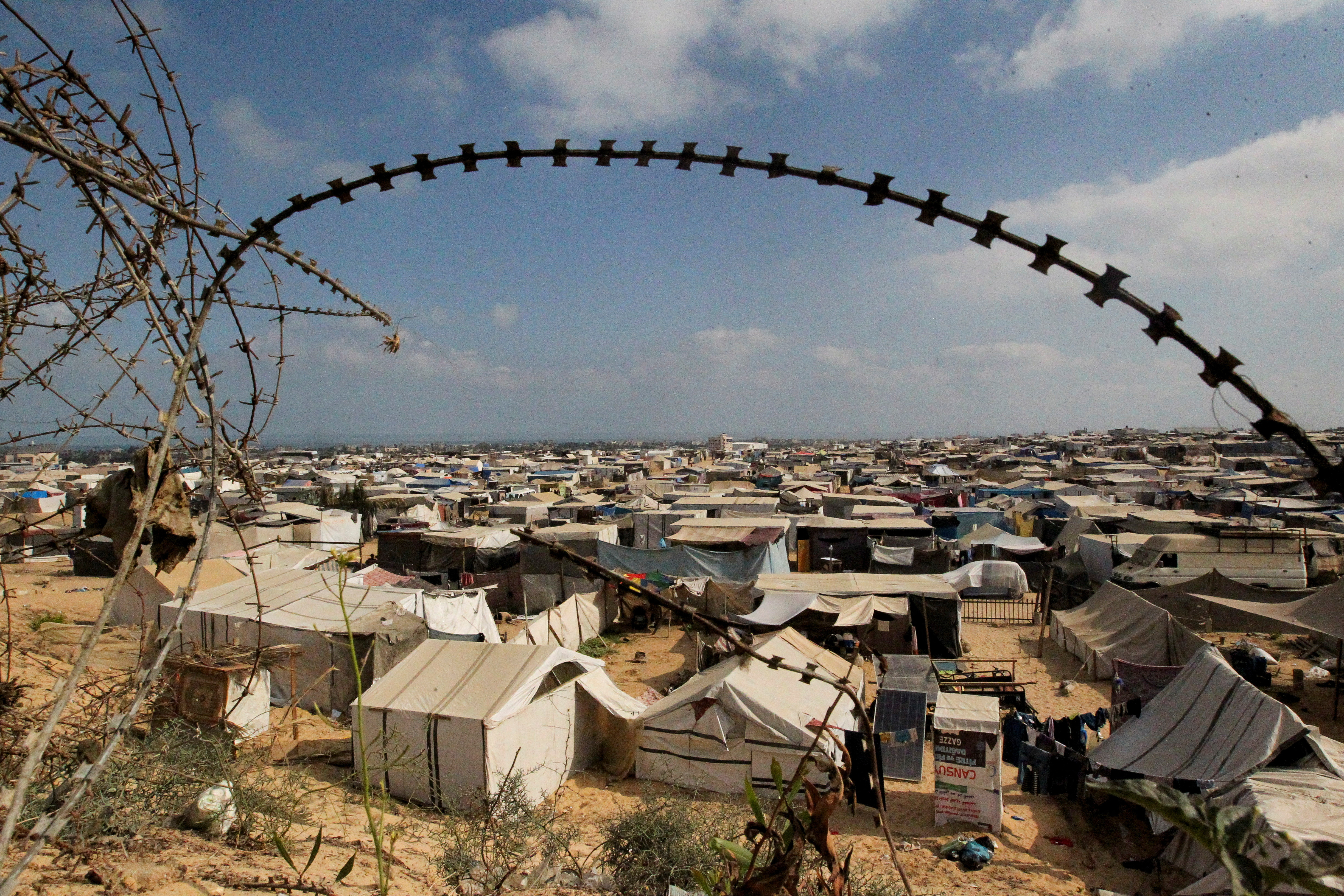 Displaced Palestinians shelter in a tent camp, in Rafah