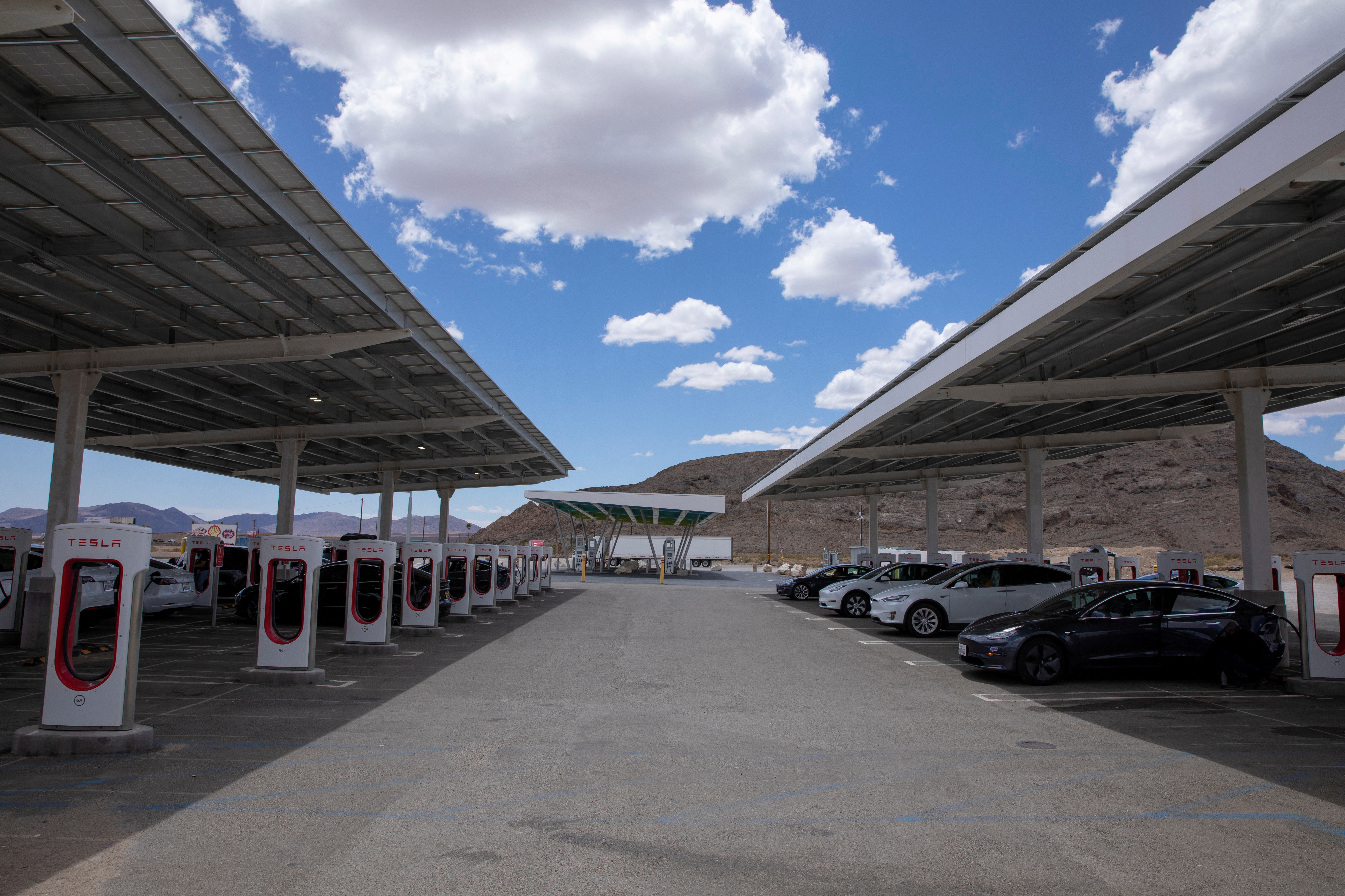 Tesla electric vehicles recharge at a large supercharging station located between Los Angeles and Las Vegas