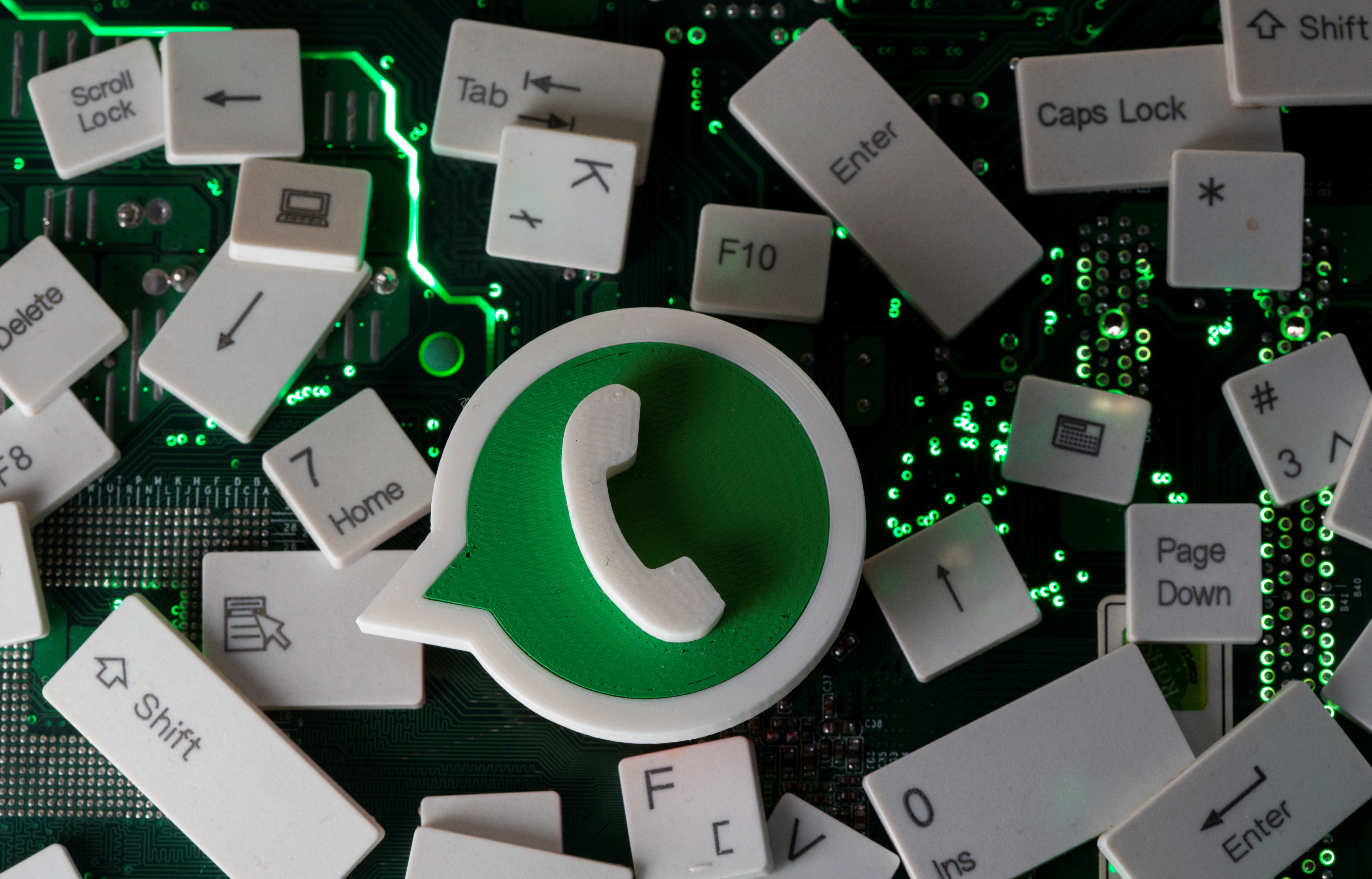 A 3D printed WhatsApp logo and keyboard buttons are placed on a computer motherboard in this illustration taken January 21, 2021. REUTERS/Dado Ruvic