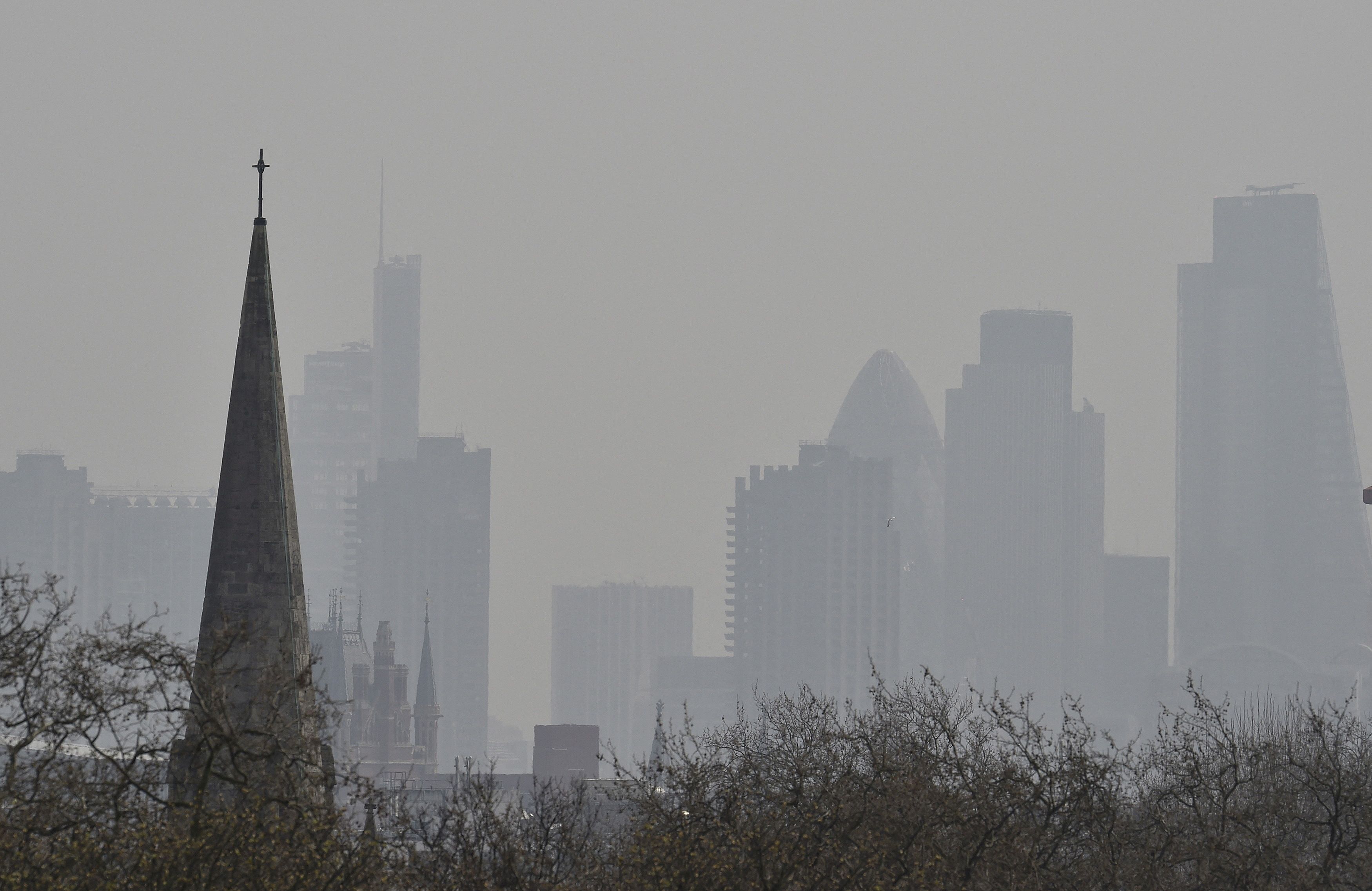 City of London financial district is seen from Primrose Hill as high air pollution obscures the skyline over London