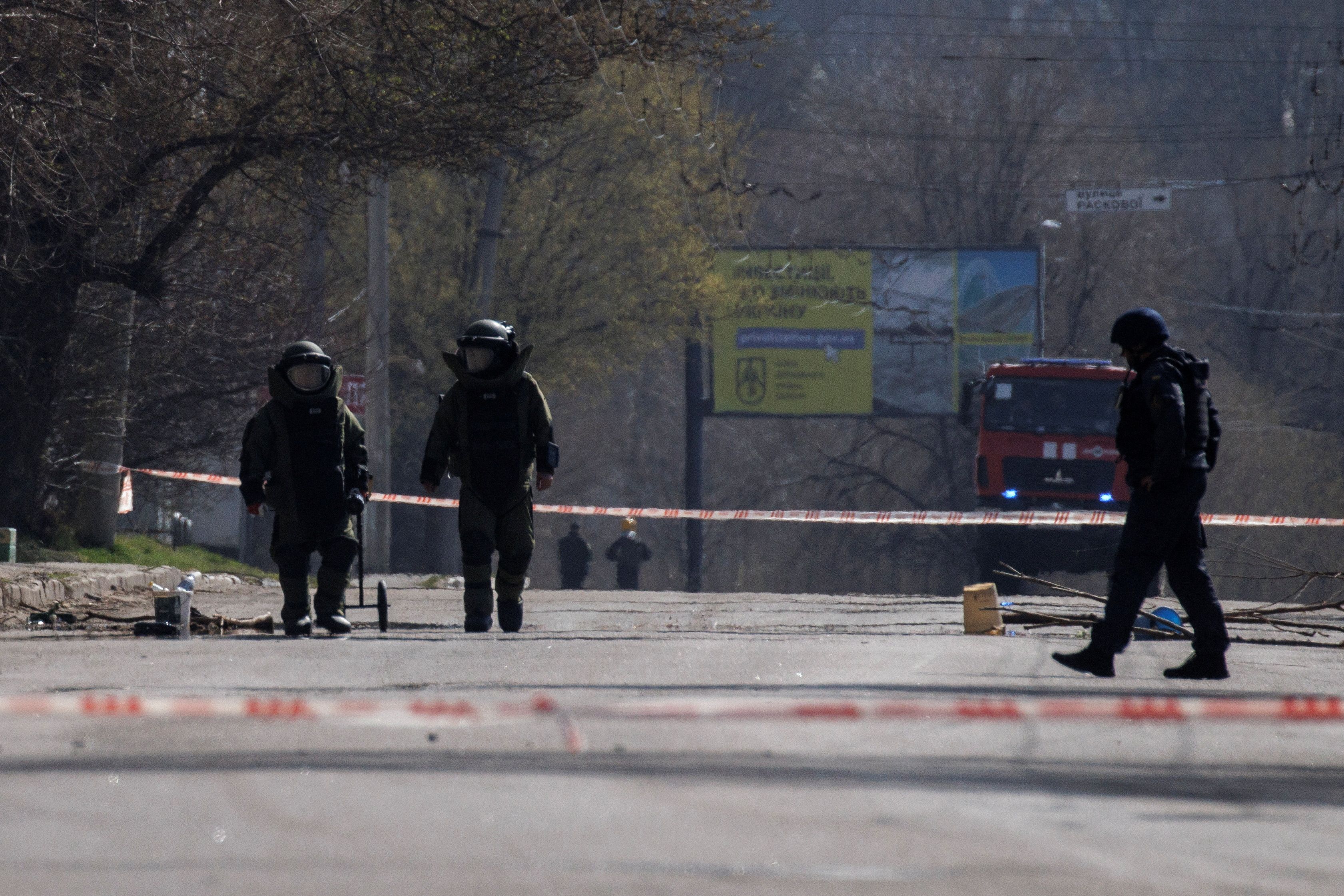 Members of a bomb disposal team conduct a controlled explosion of unexploded ordnance, in Kharkiv