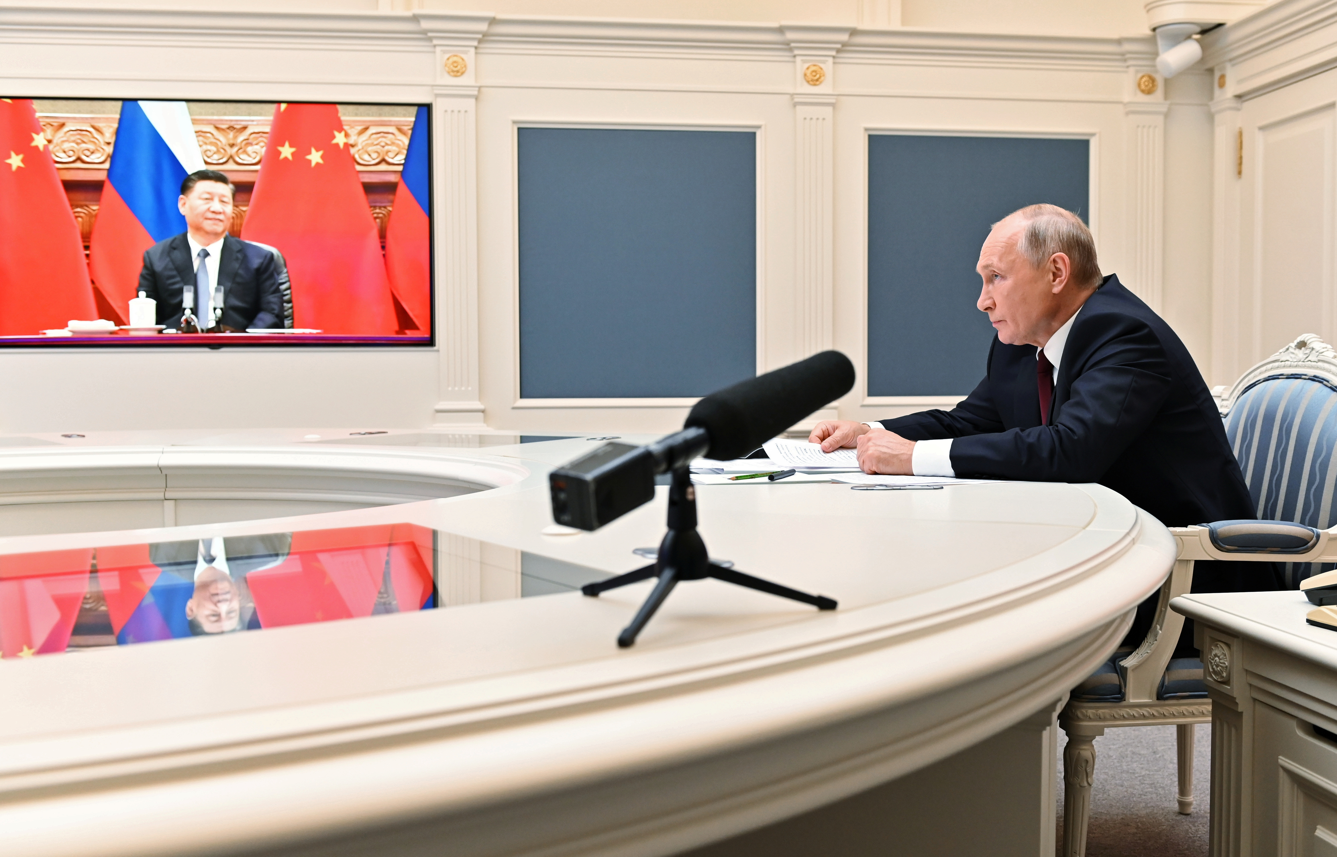 Russian President Vladimir Putin takes part in a video conference call with Chinese President Xi Jinping in Moscow