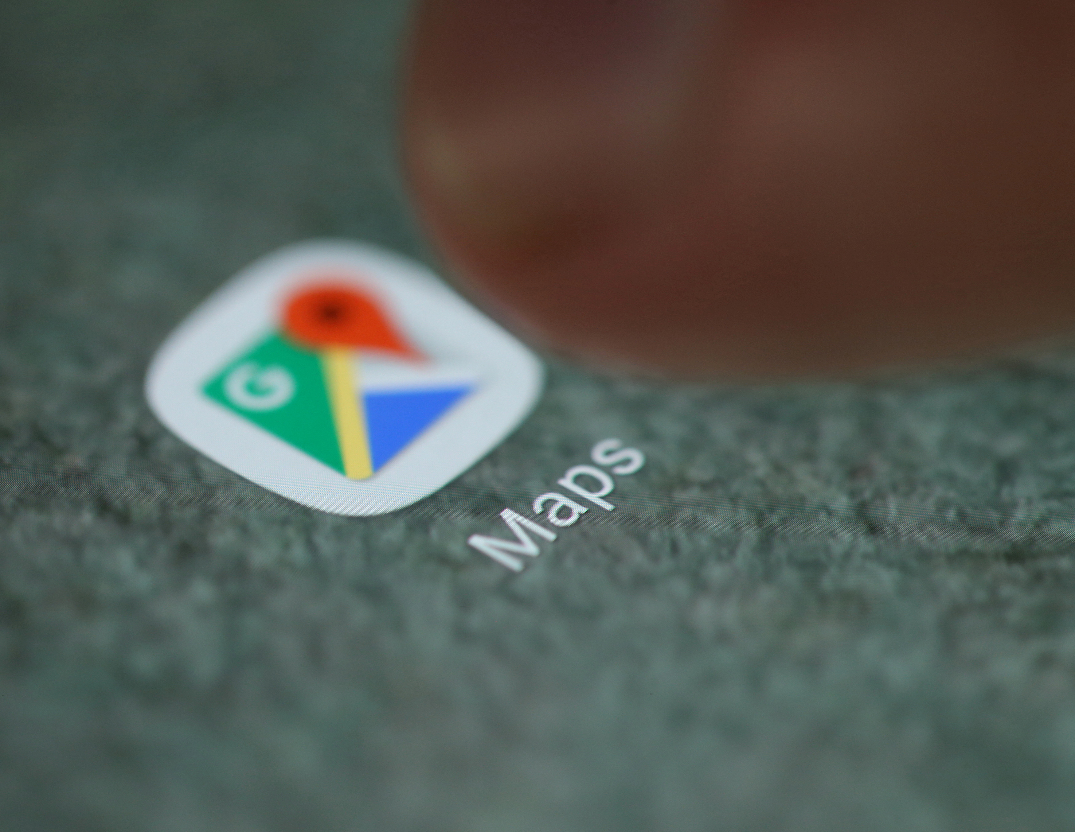 The Google Maps app logo is seen on a smartphone in this illustration