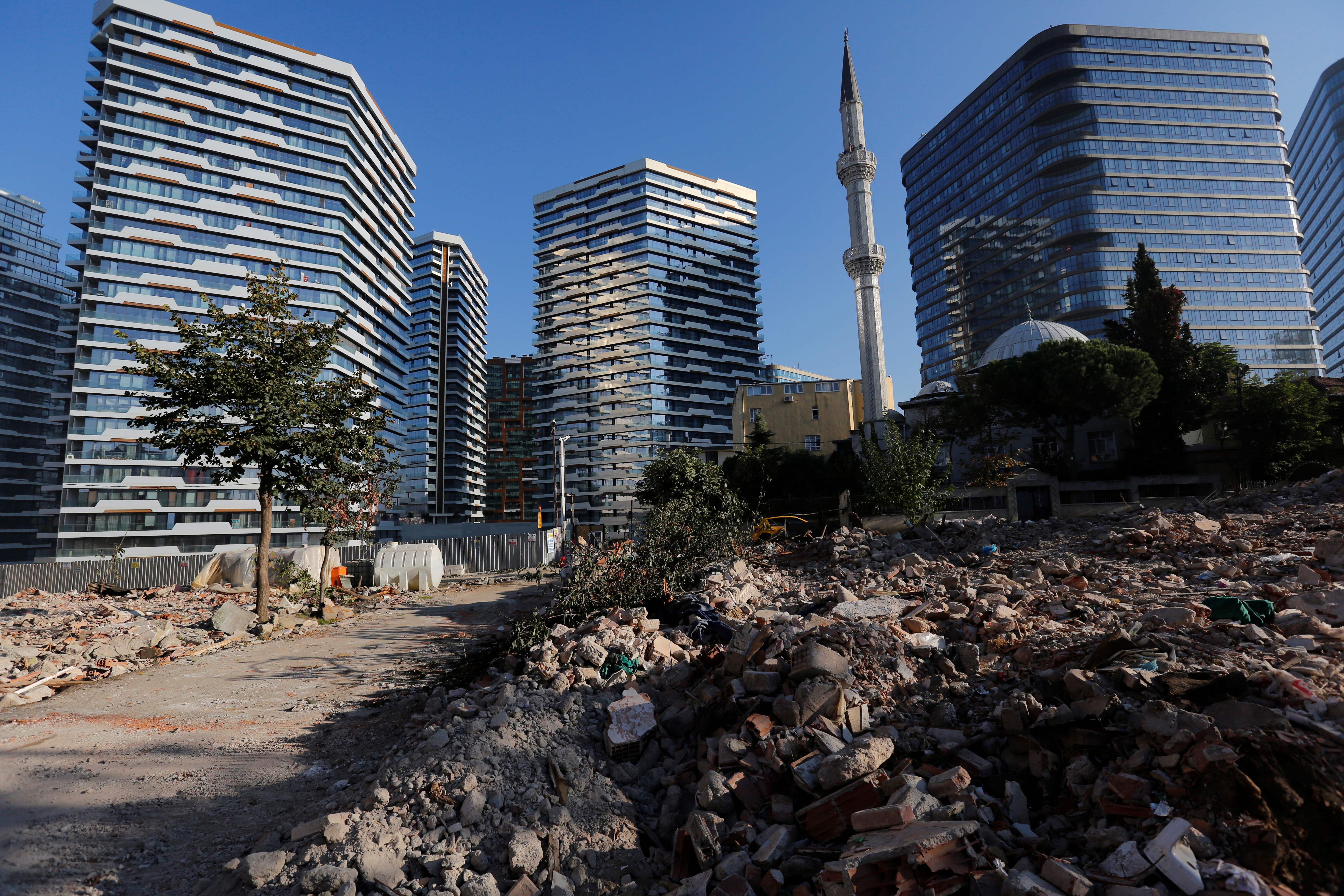 Debris from houses is seen in front of brand new residential buildings at an urban transformation project area in Istanbul
