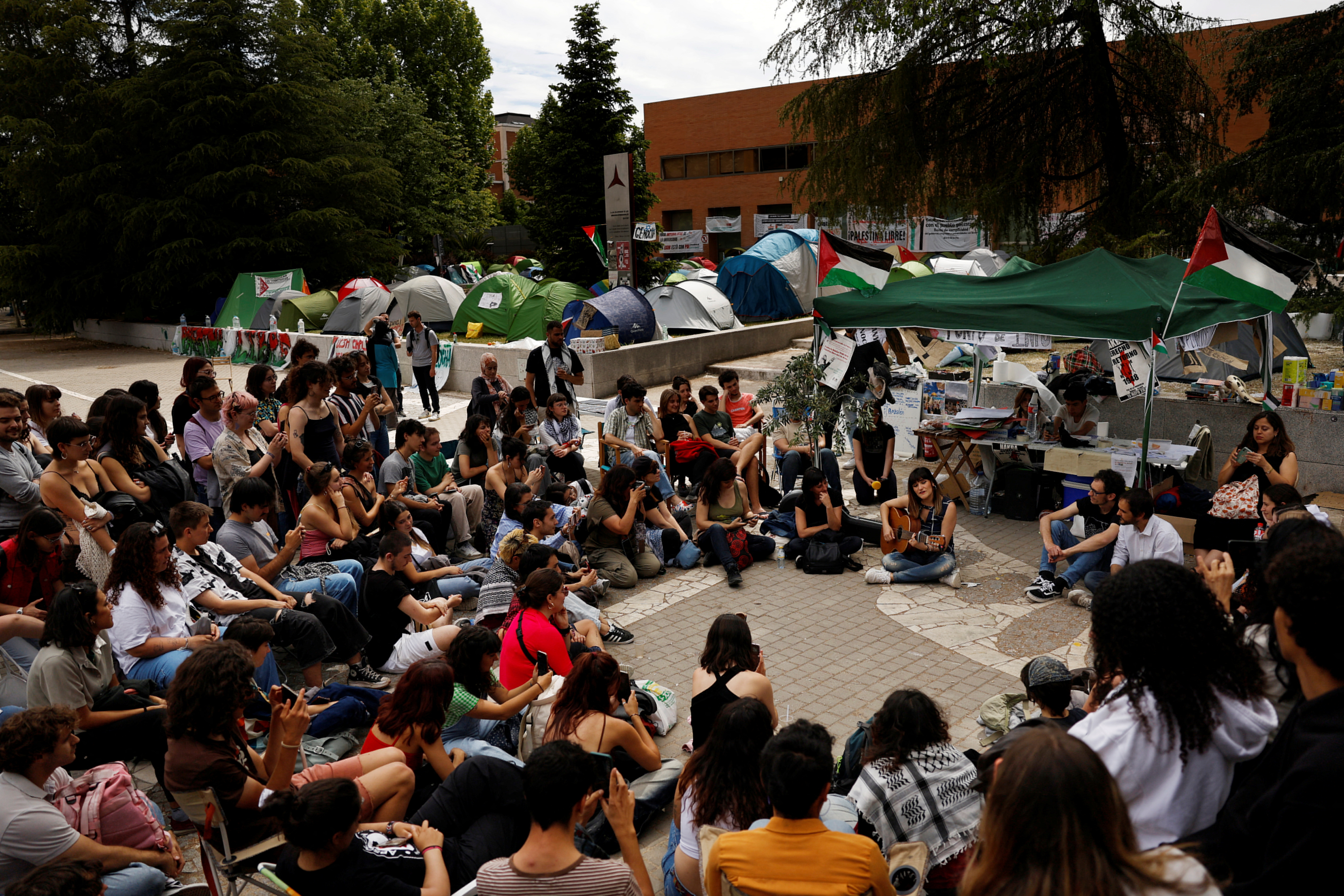 People gather at a pro-Palestinian encampment by students of the Complutense University in Madrid