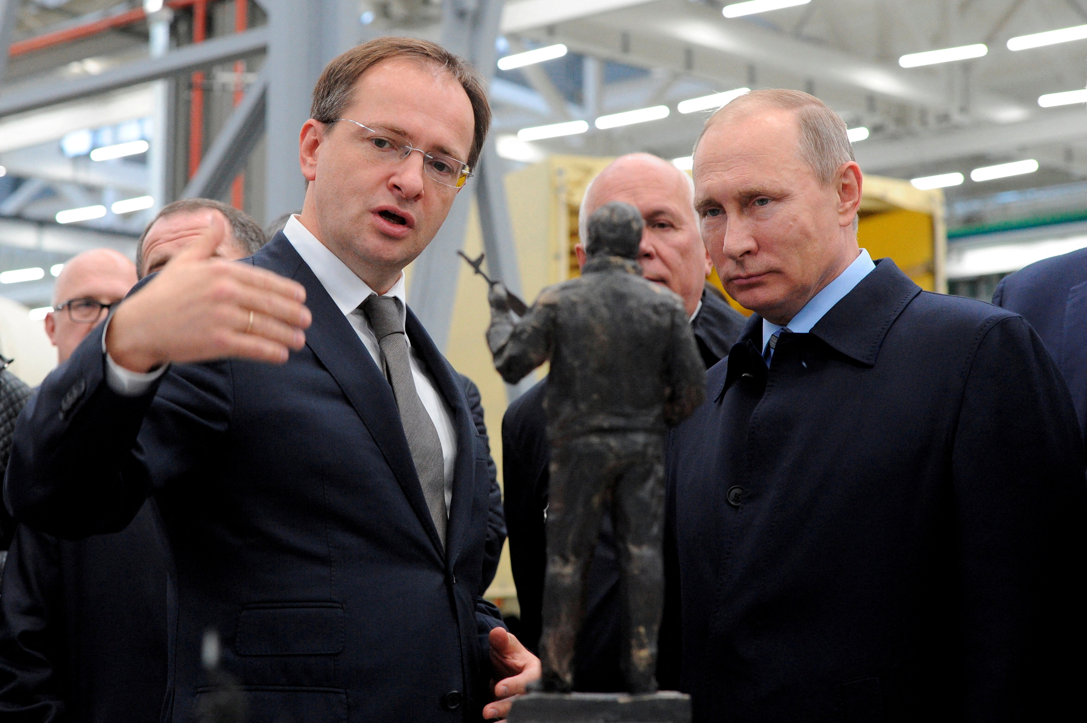 Russian President Putin listens to Culture Minister Medinsky as they watch the project of a monument to Kalashnikov, the Russian inventor of the AK-47 assault rifle, during a visit at firearms maker Kalashnikov Concern in Izhevsk, Russia