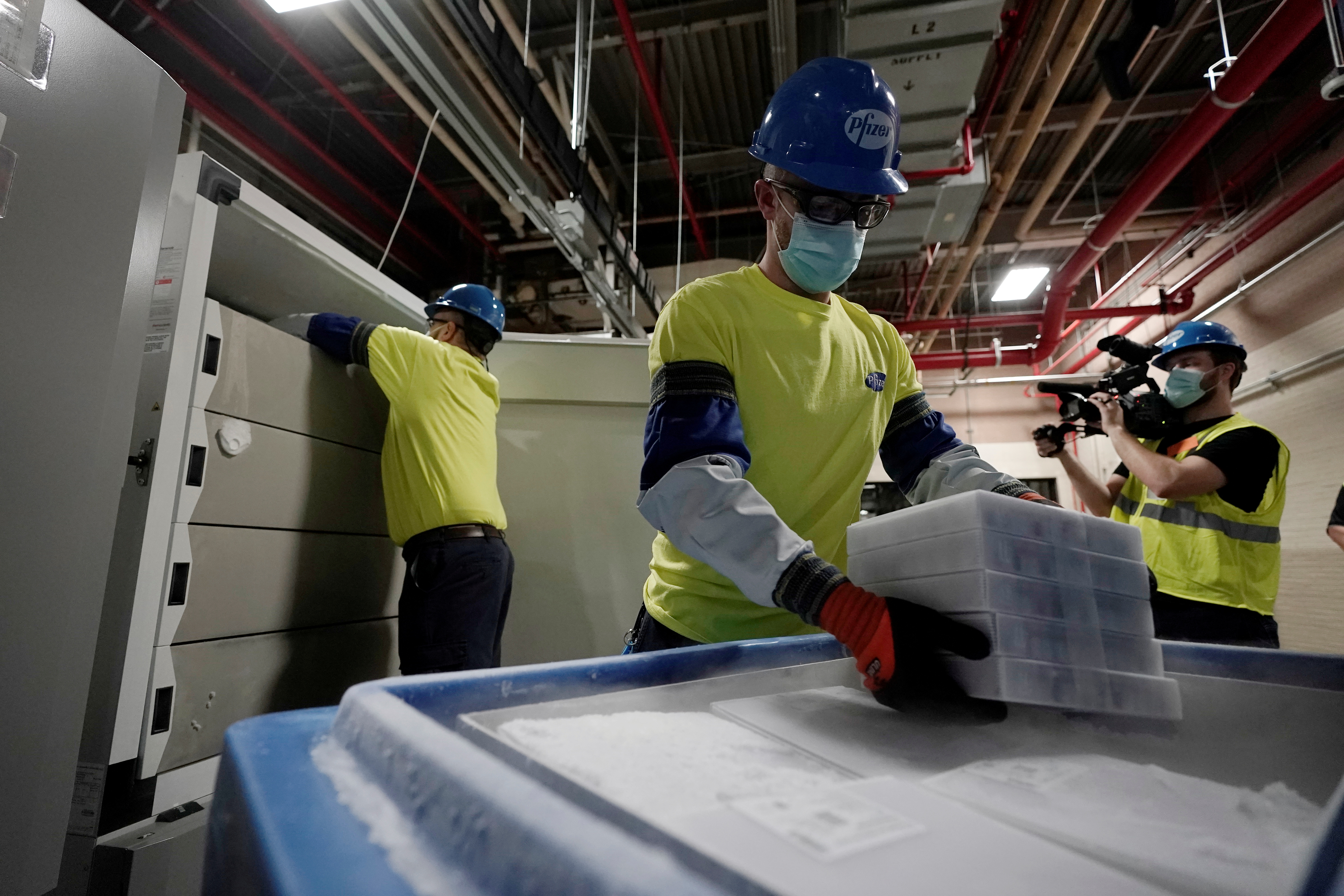 Boxes containing the Pfizer-BioNTech COVID-19 vaccine are prepared to be shipped at the Pfizer Global Supply Kalamazoo manufacturing plant in Portage