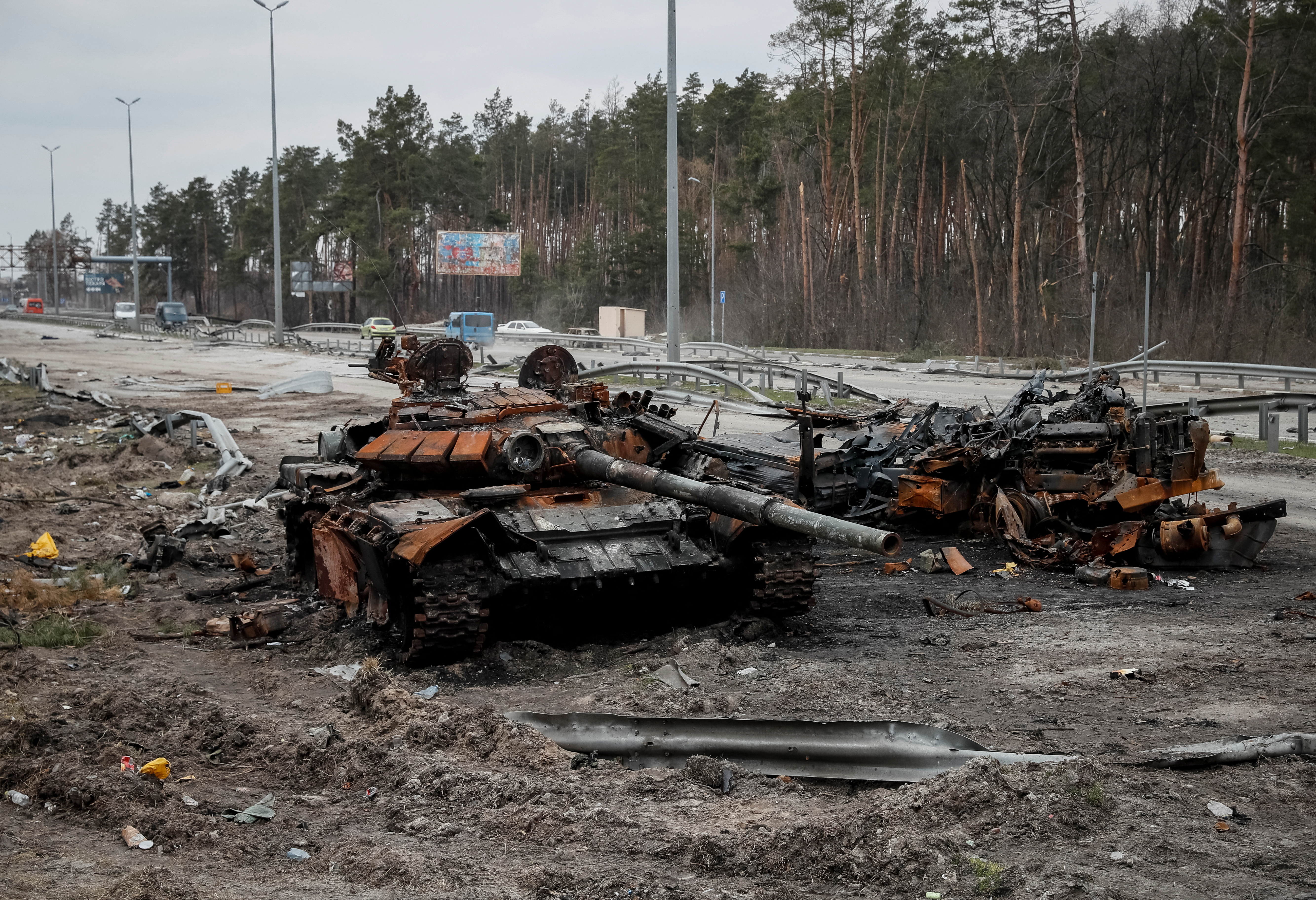 A destroyed Russian tank is seen on a highway in Kyiv region