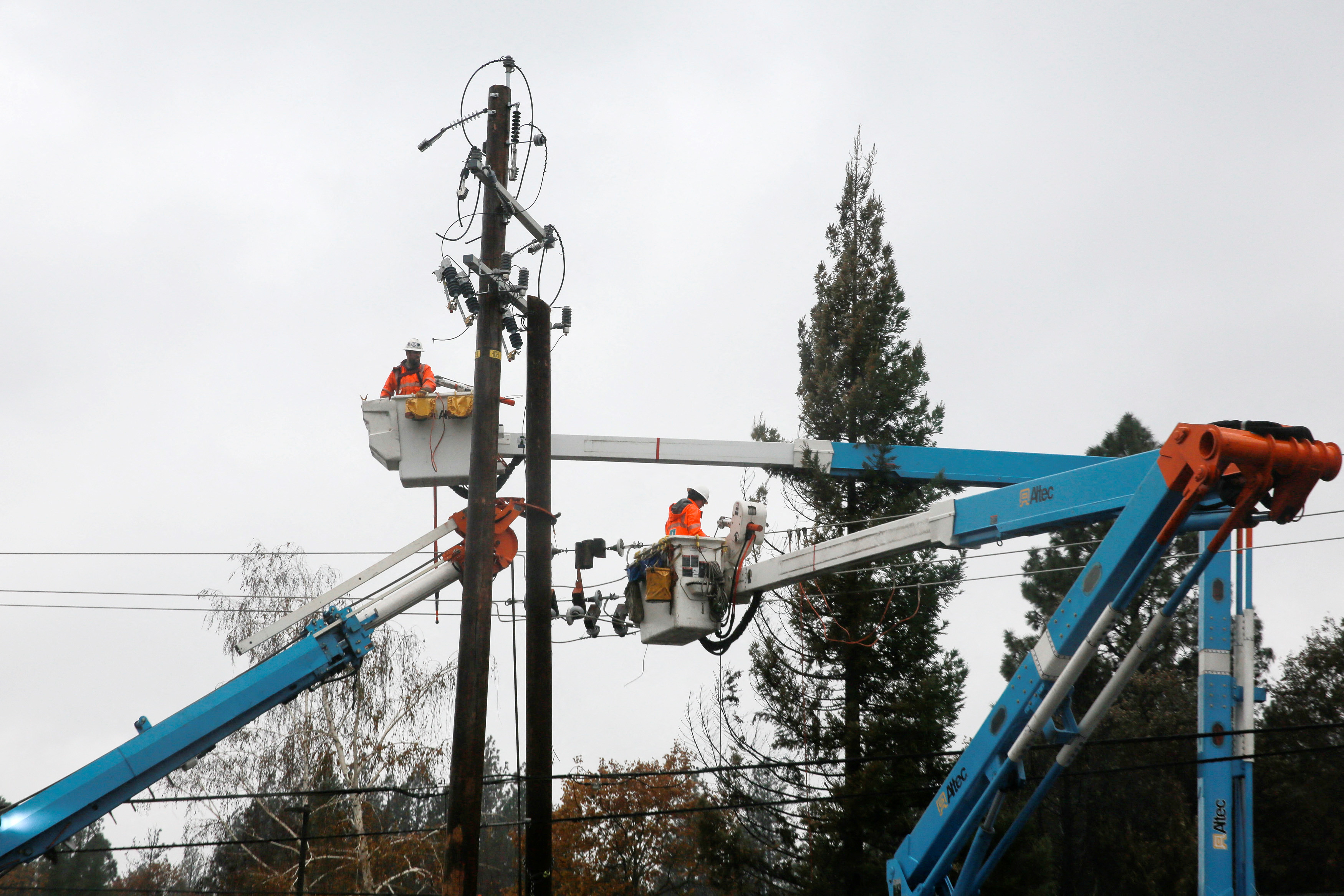 PG&E crew work on power lines to repair damage caused by the Camp Fire in Paradise,