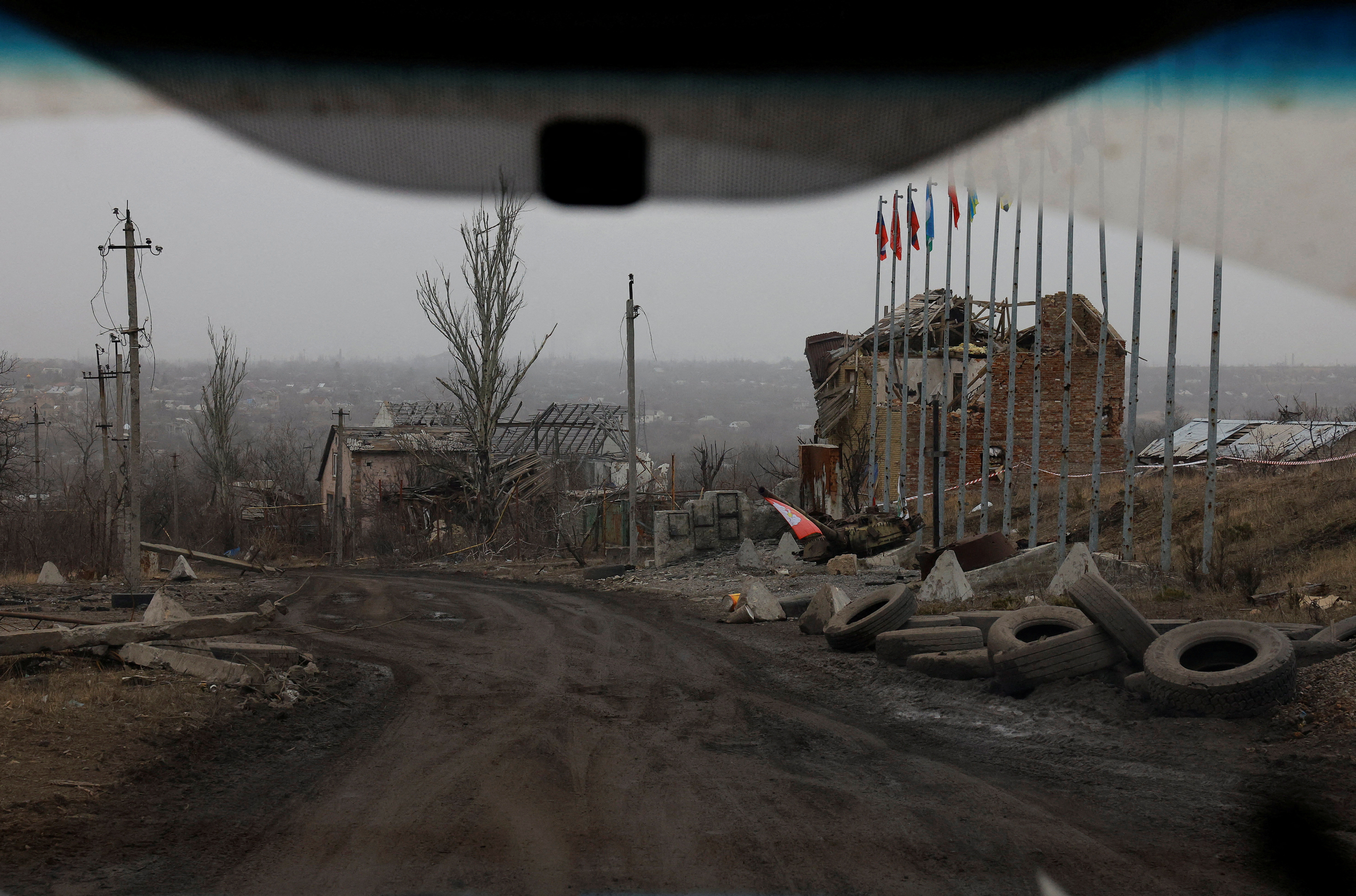 A view from a car shows destroyed buildings in Avdiivka