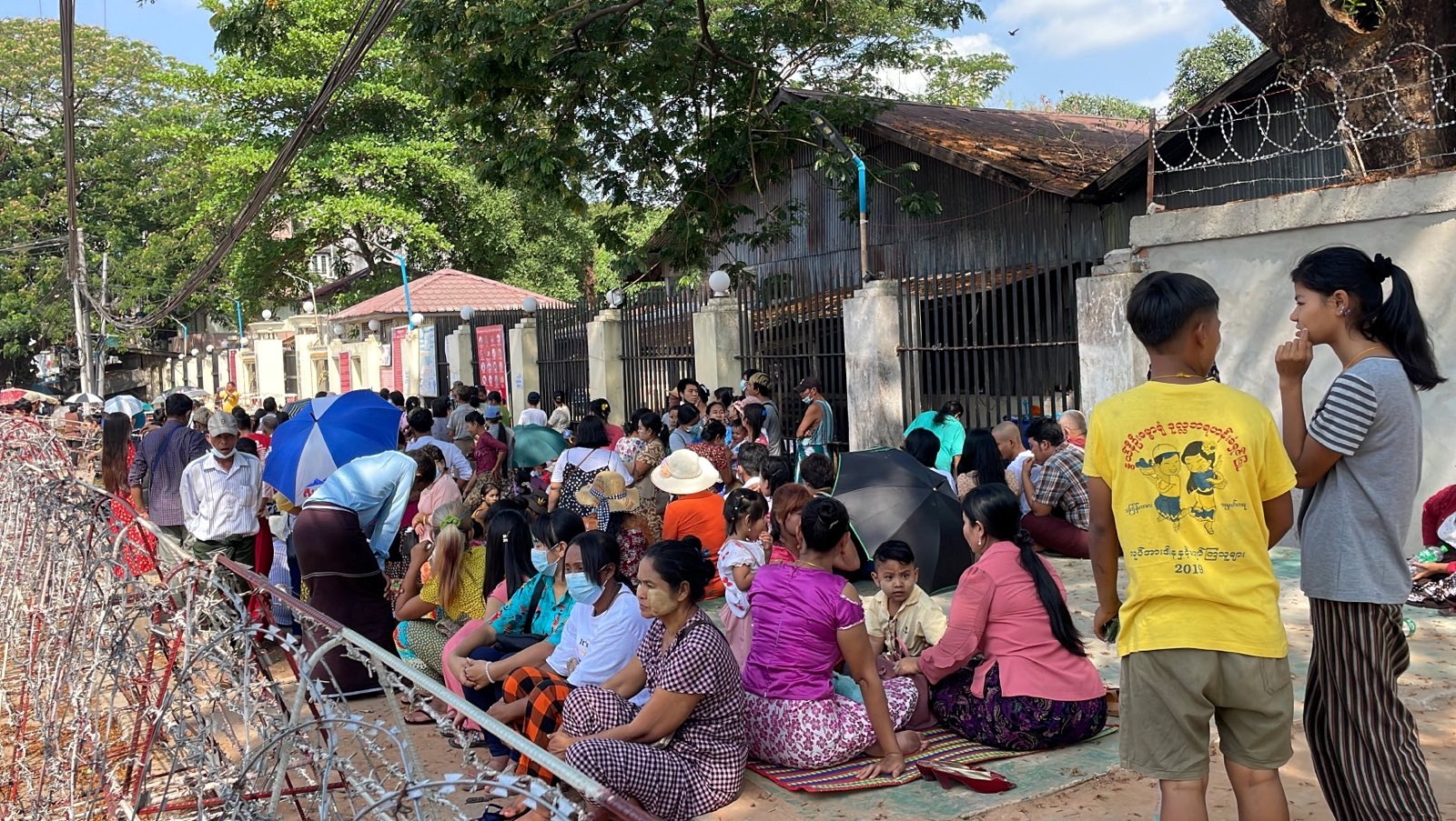 People wait at Insein prison in hopes of the release of their families members who were arrested due to the anti-coup protests, in Yangon