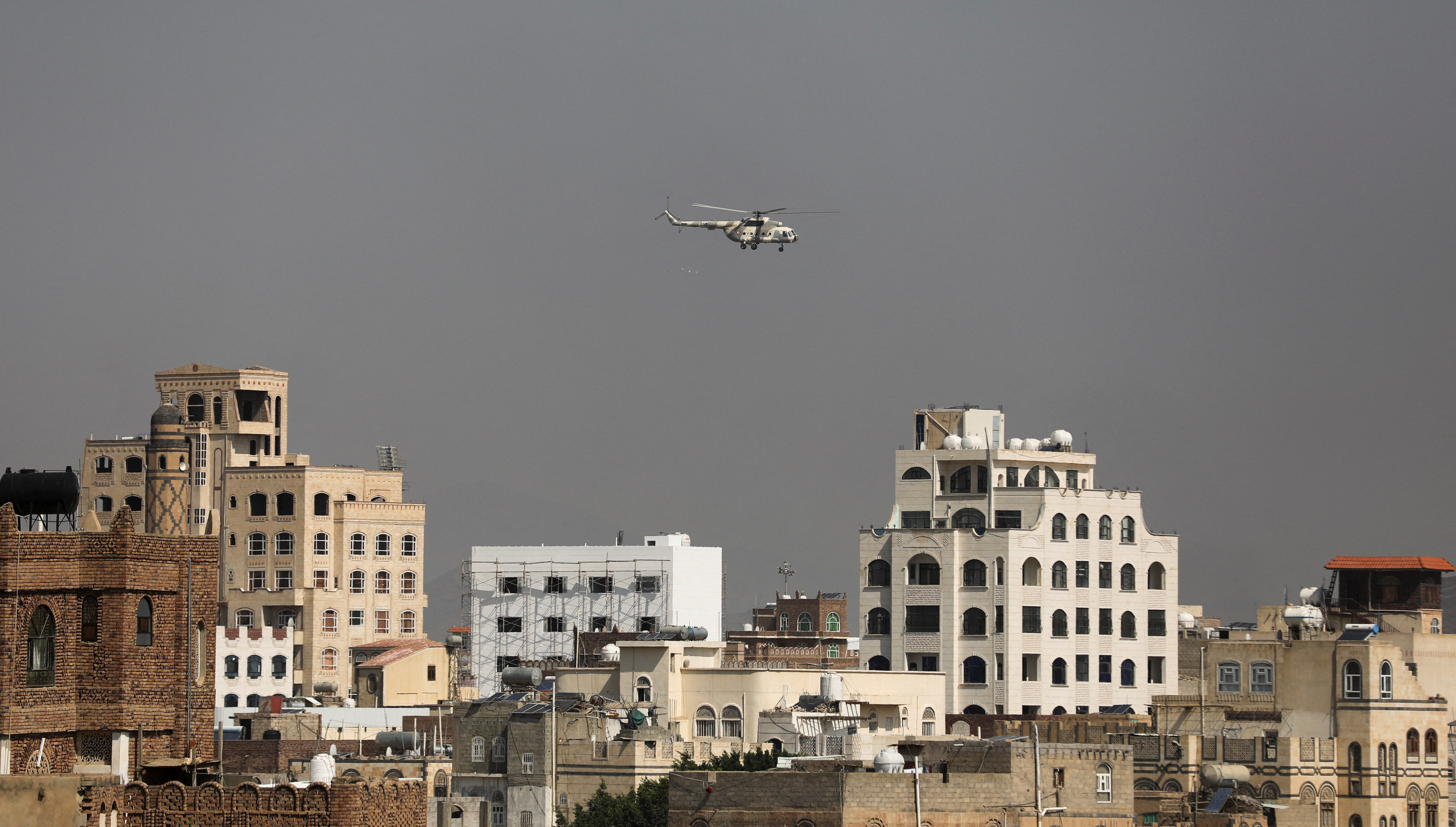 Military helicopter, operated by the Houthis, flies over Sanaa