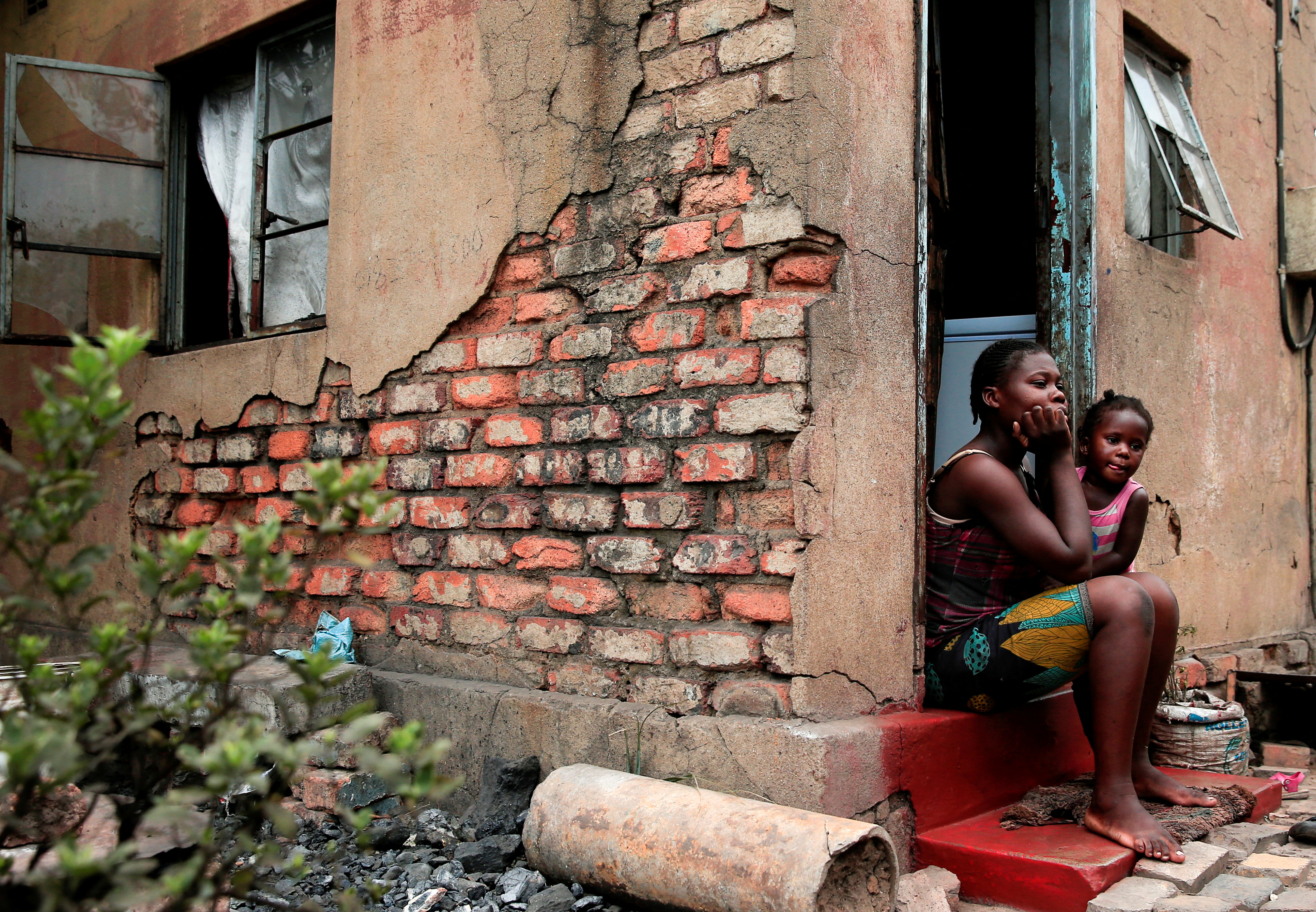 Zanzele Moyo sits outside her house in Madhumabisa surburb in Hwange, Zimbabwe