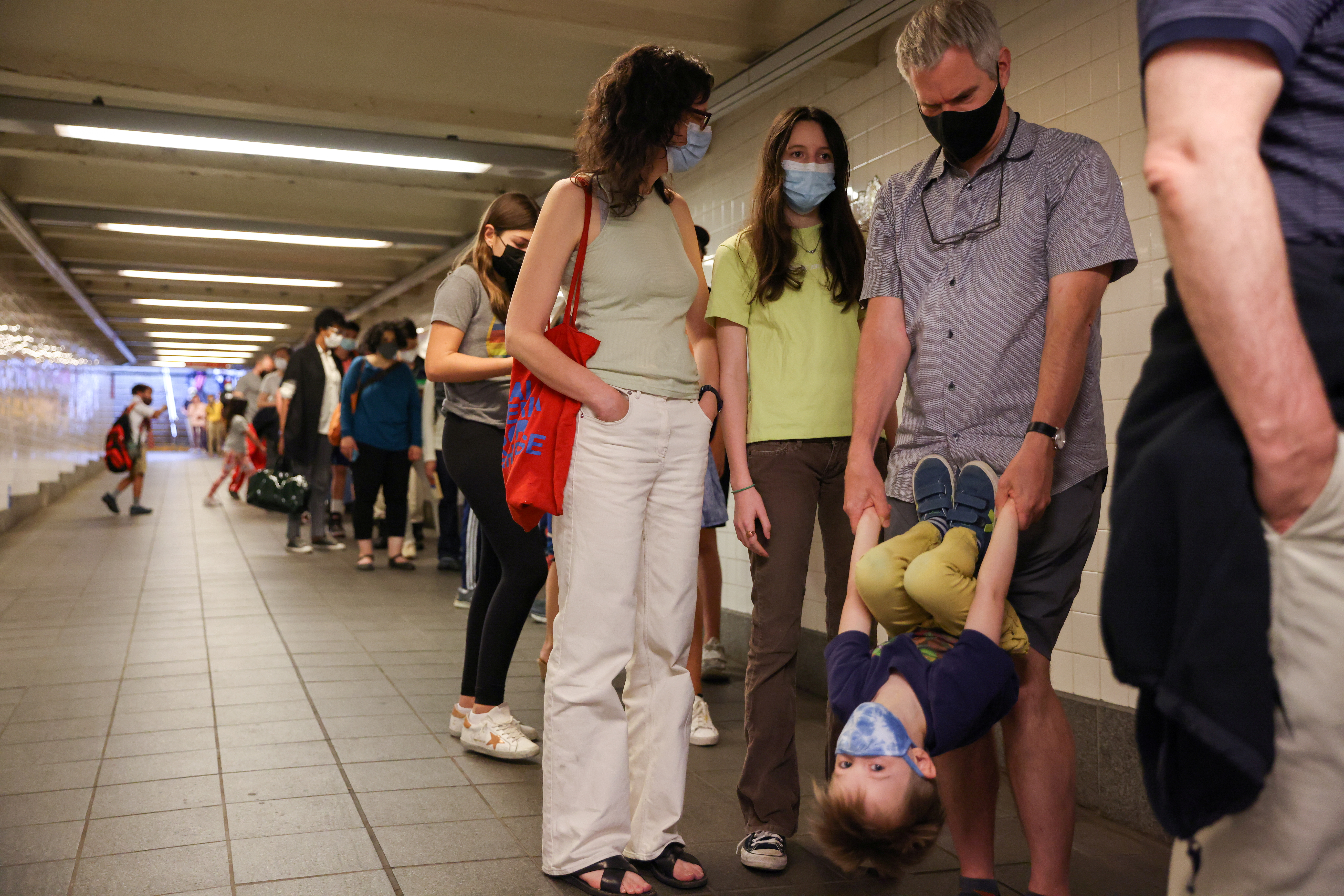 Jane Hassebroek waits in line to receive a COVID-19 vaccination outside the American Museum of Natural History with her family in Manhattan