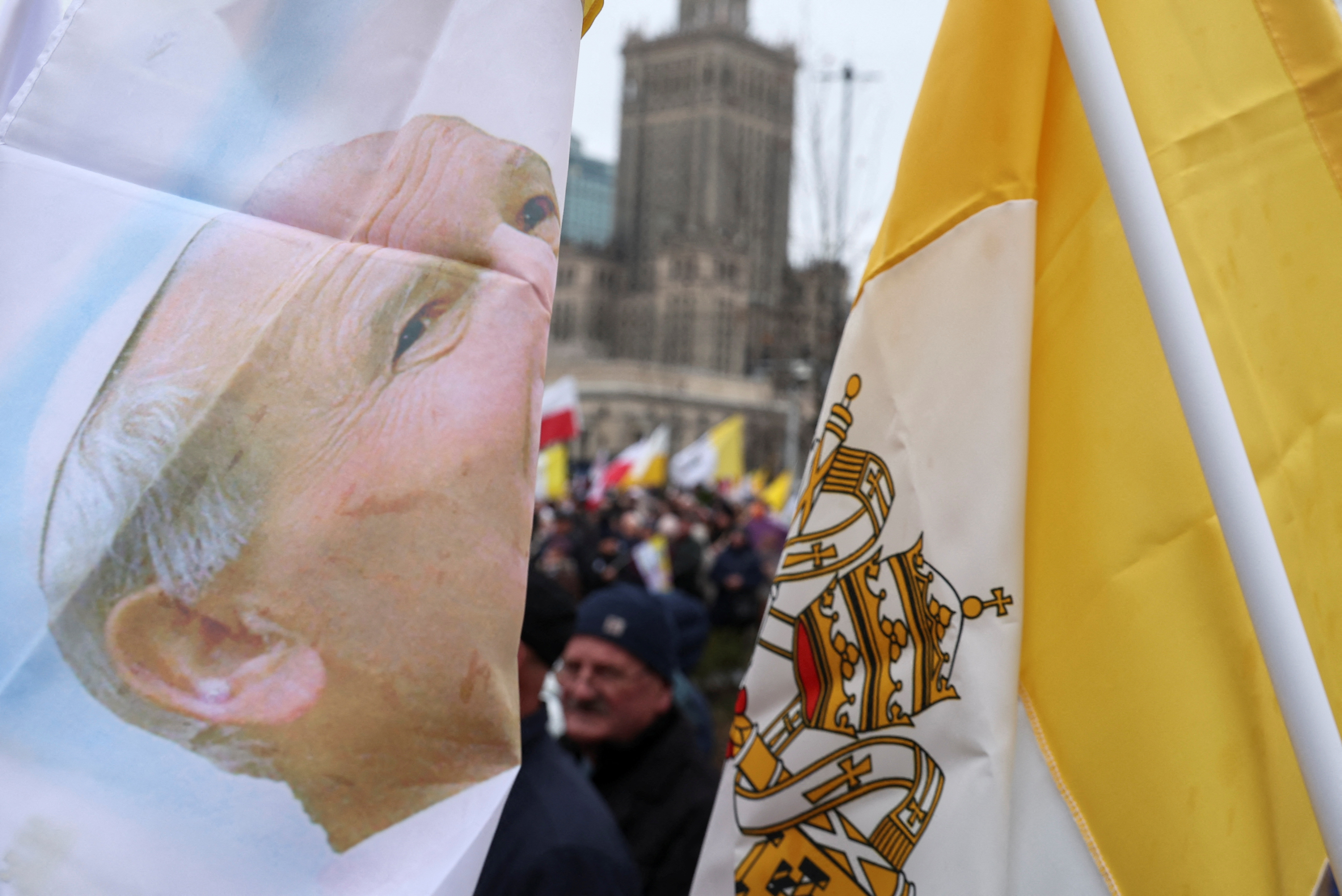 People march in defense of pope John Paul II on his death anniversary in Warsaw