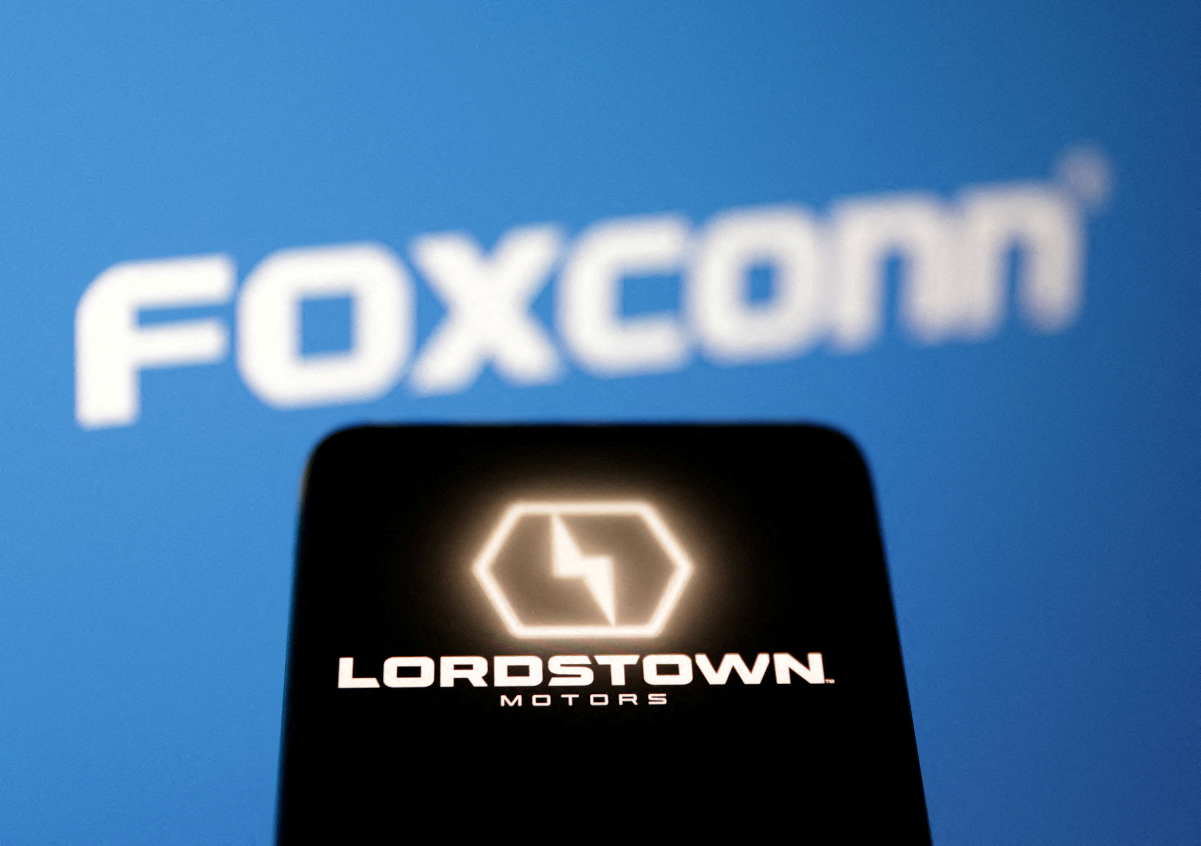 Illustration shows Lordstown Motors and Foxconn logos