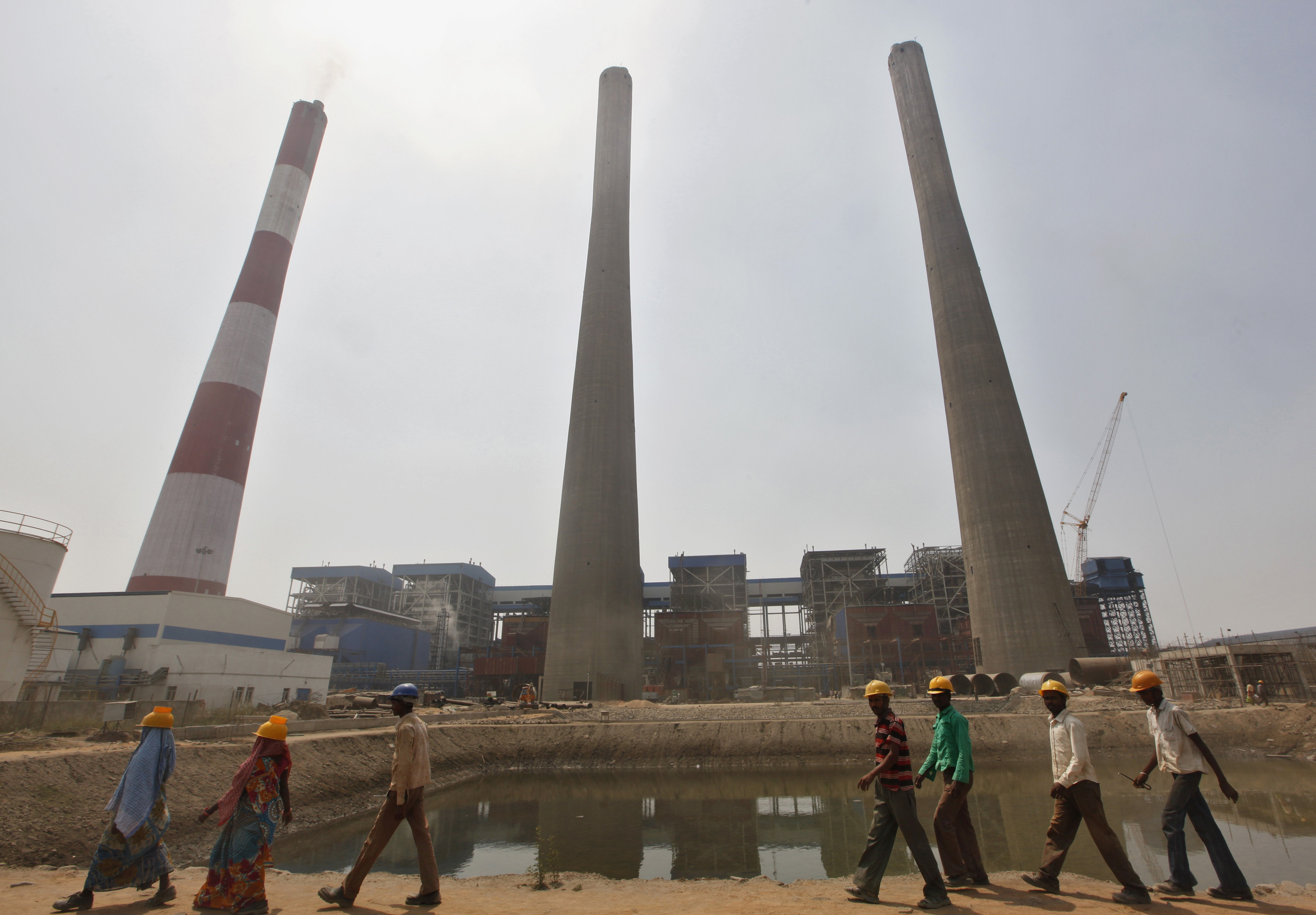 Workers walk inside the Jindal Power and Steel Ltd. complex at Nisha village