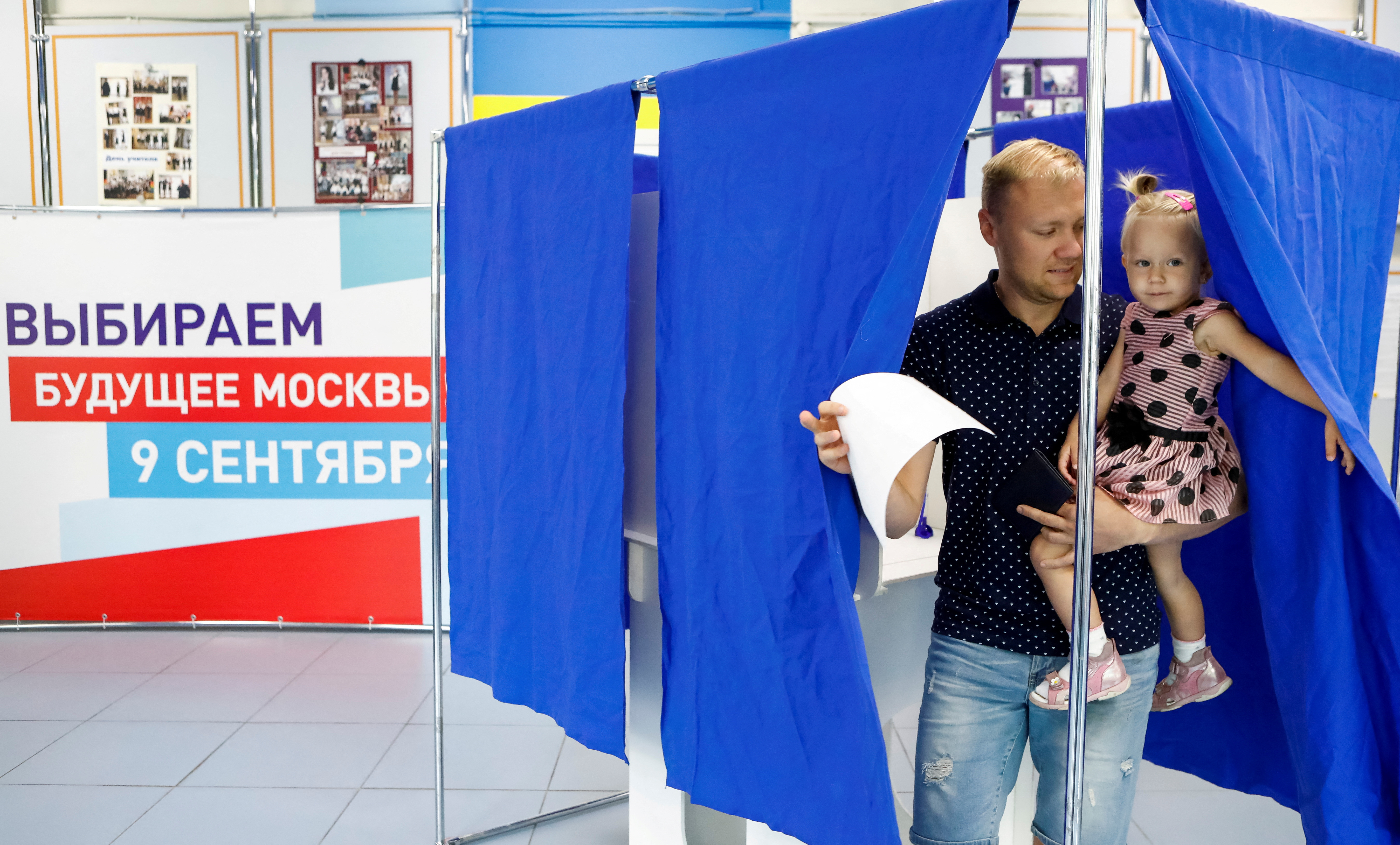 A man leaves a voting booth during mayor election at a polling station in Moscow
