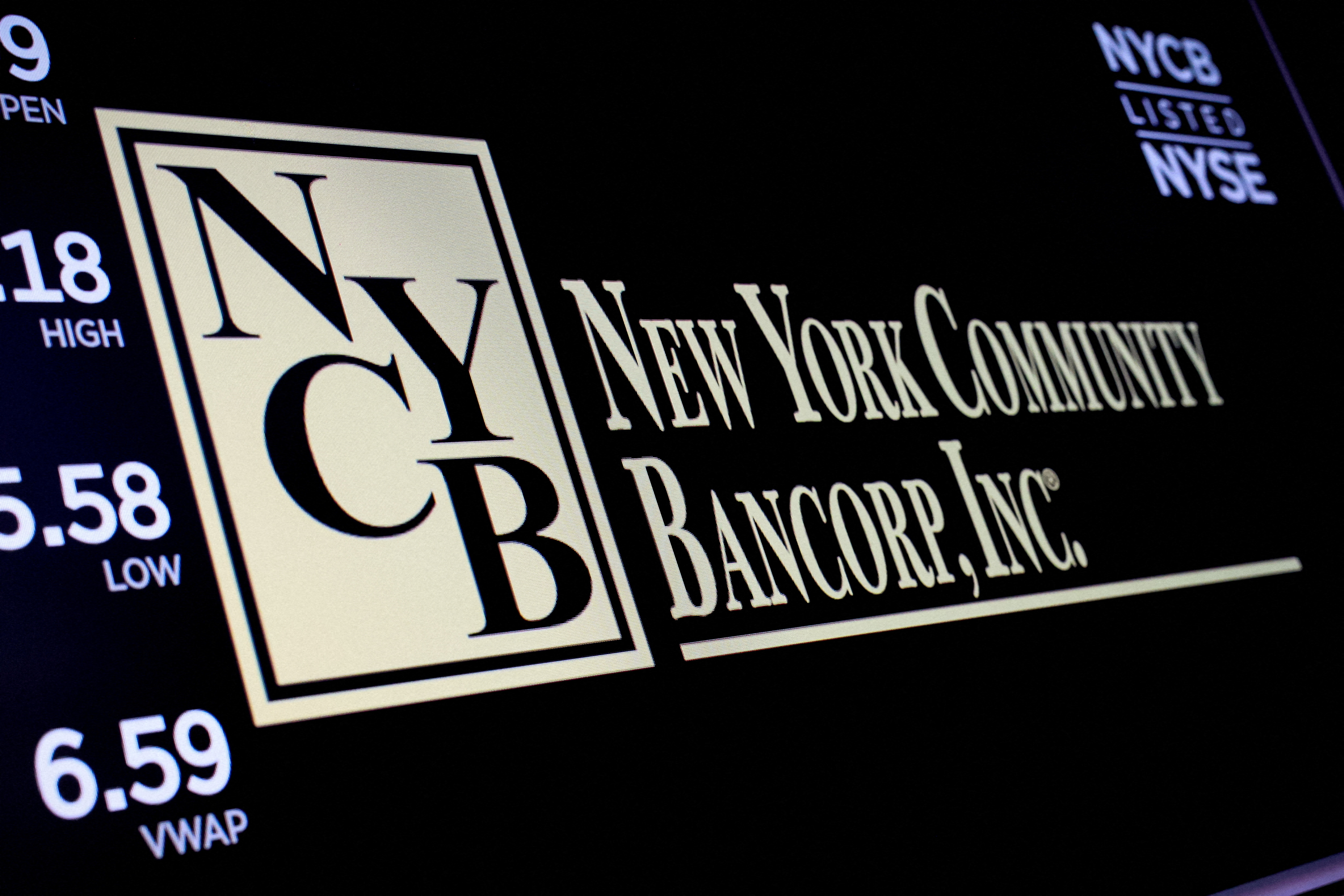 A screen displays the trading information for New York Community Bancorp on the the NYSE in New York