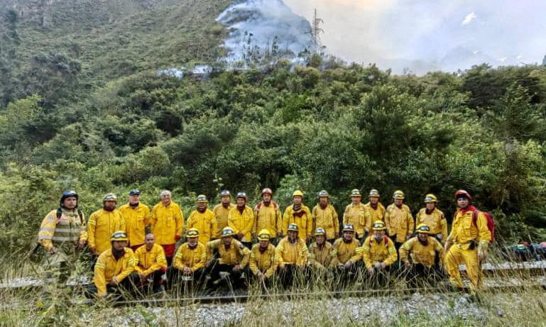 Emergency personnel work to put out a forest fire in Machu Picchu