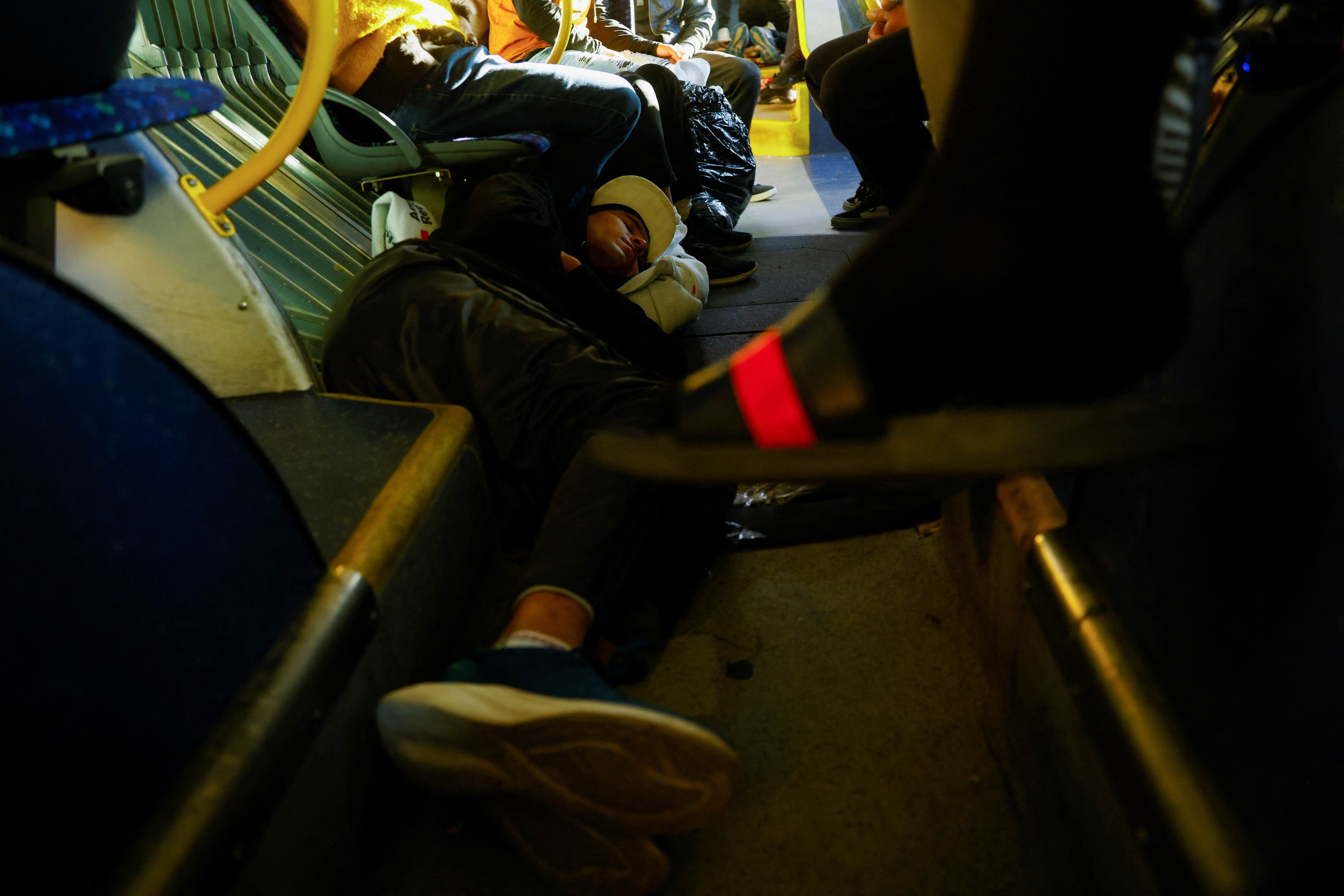 Migrants rest in a bus on the day that U.S. President Biden and first lady Jill Biden visit El Paso