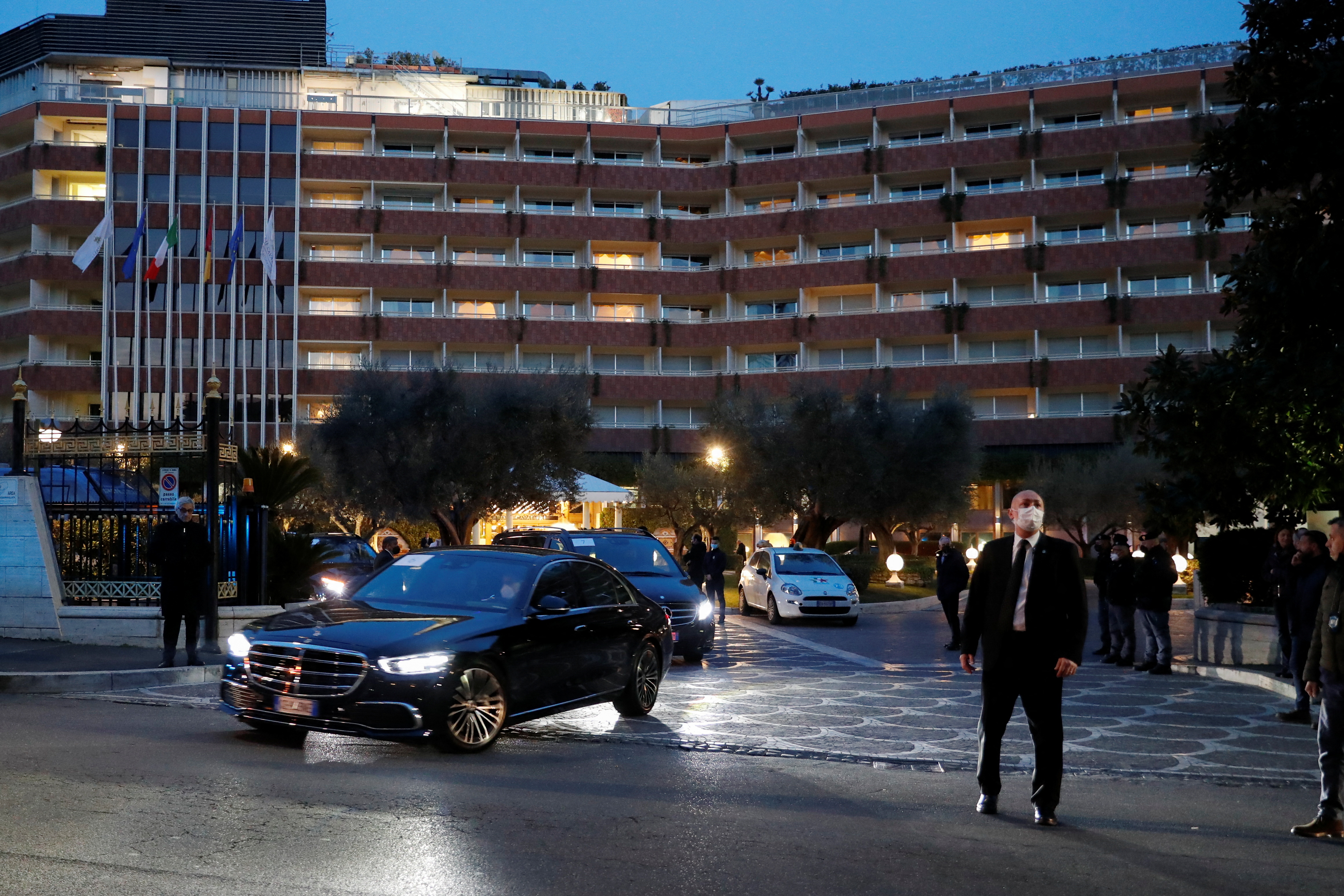 Members of the Chinese delegation leave the Rome Cavalieri a Waldorf Astoria hotel, in Rome