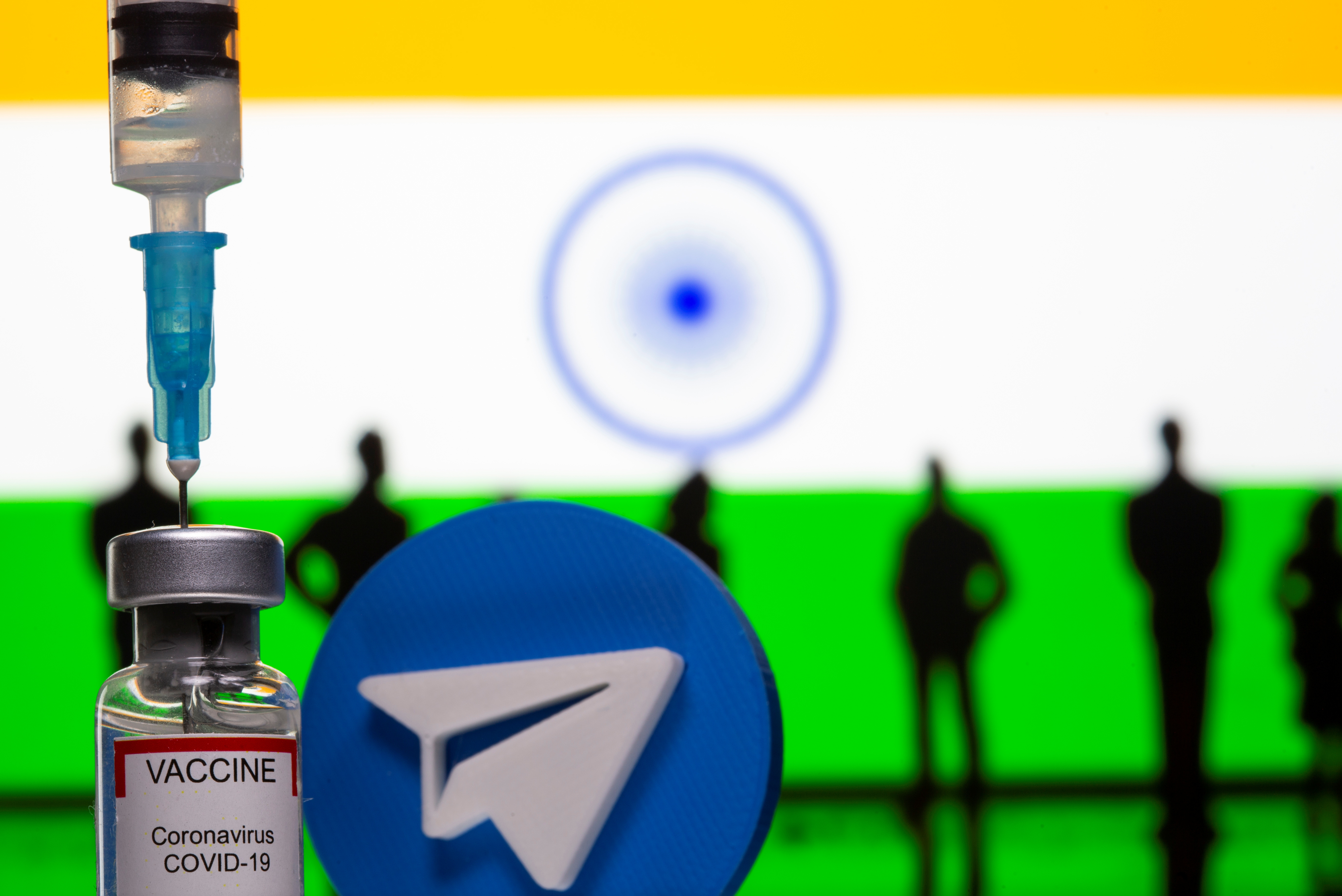 A 3D-printed Telegram app logo, small toy figurines, a syringe and vial labelled 