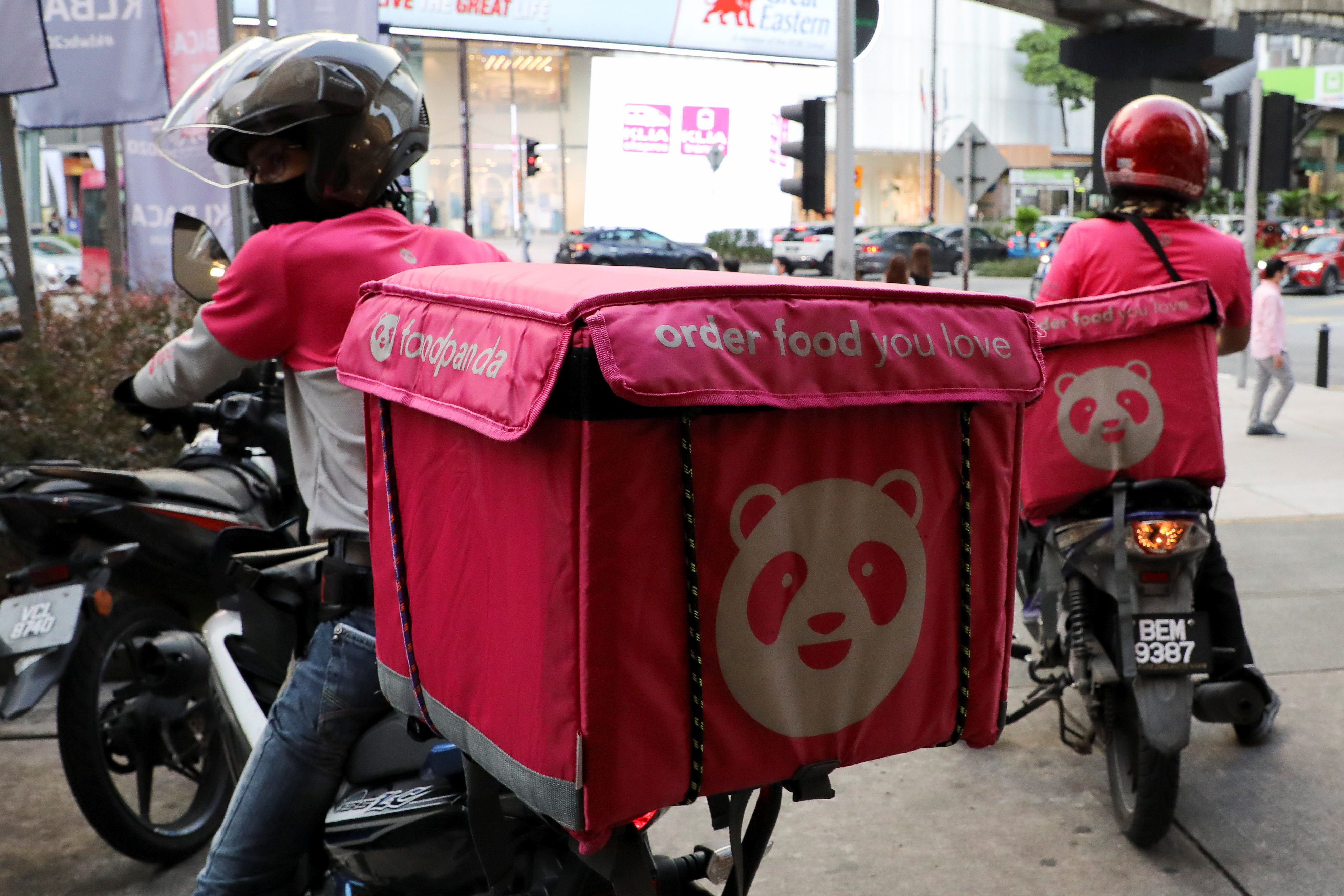 Foodpanda riders get ready for deliveries outside a restaurant, amid the coronavirus disease (COVID-19) outbreak in Kuala Lumpur
