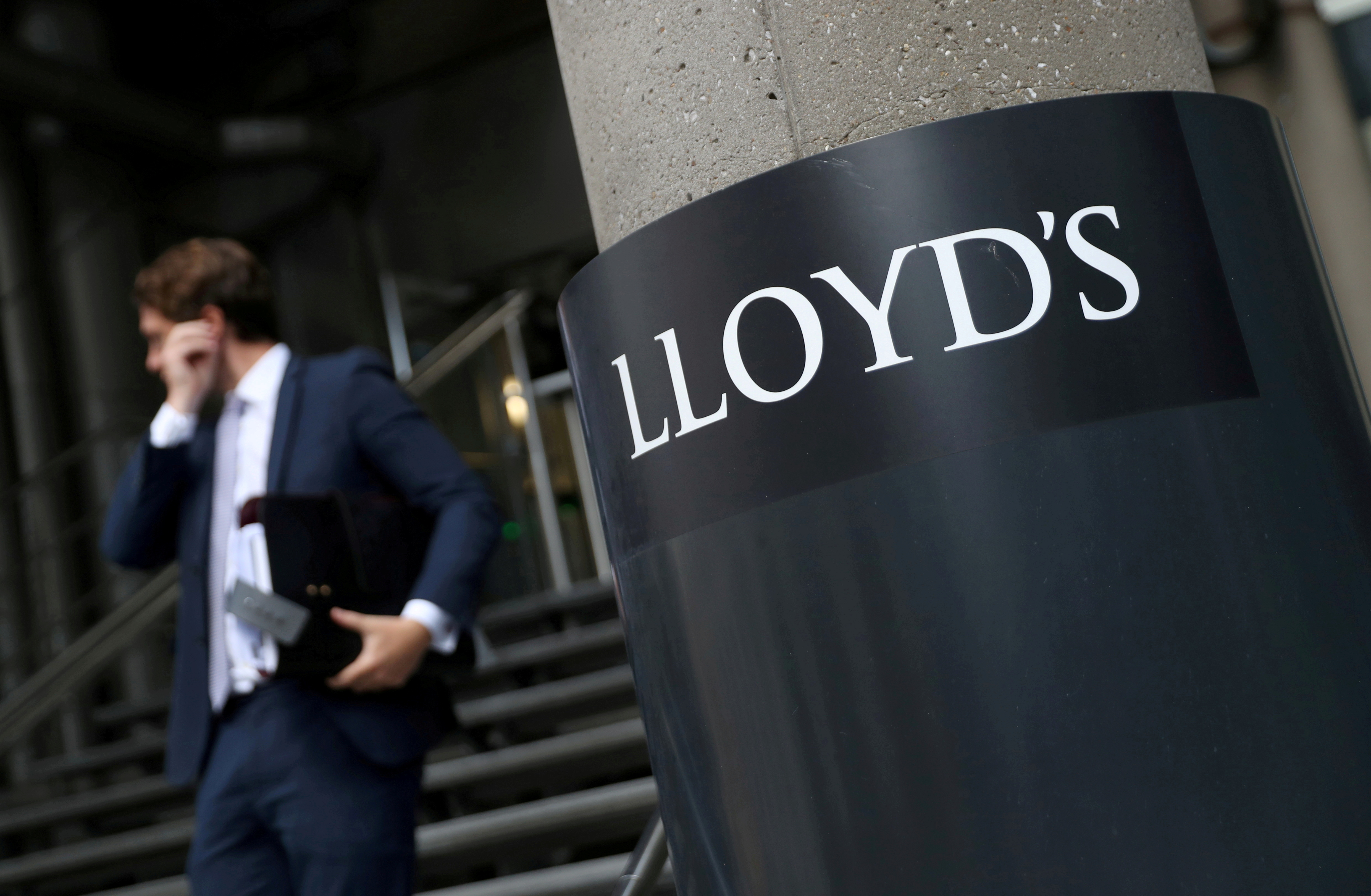 A man walks out of Lloyd's of London's headquarters in the City of London