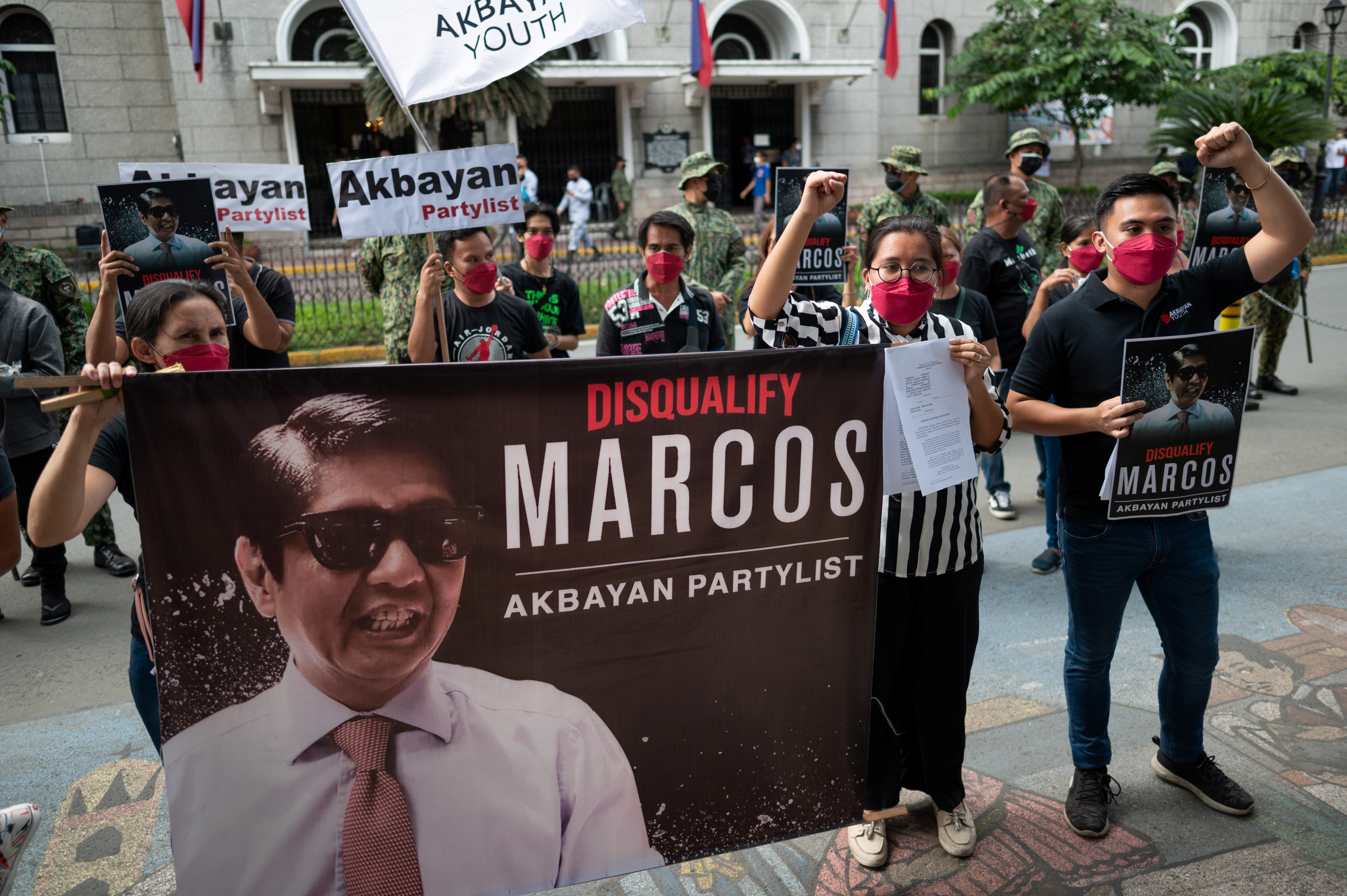 Members of Akbayan Partylist gather outside the Commission on Elections during the filing of a petition for disqualification against late dictator's son Ferdinand “Bongbong” Marcos Jr., who is running for the presidency in the 2022 national elections, in Manila, Philippines, December 2, 2021. REUTERS/Lisa Marie David