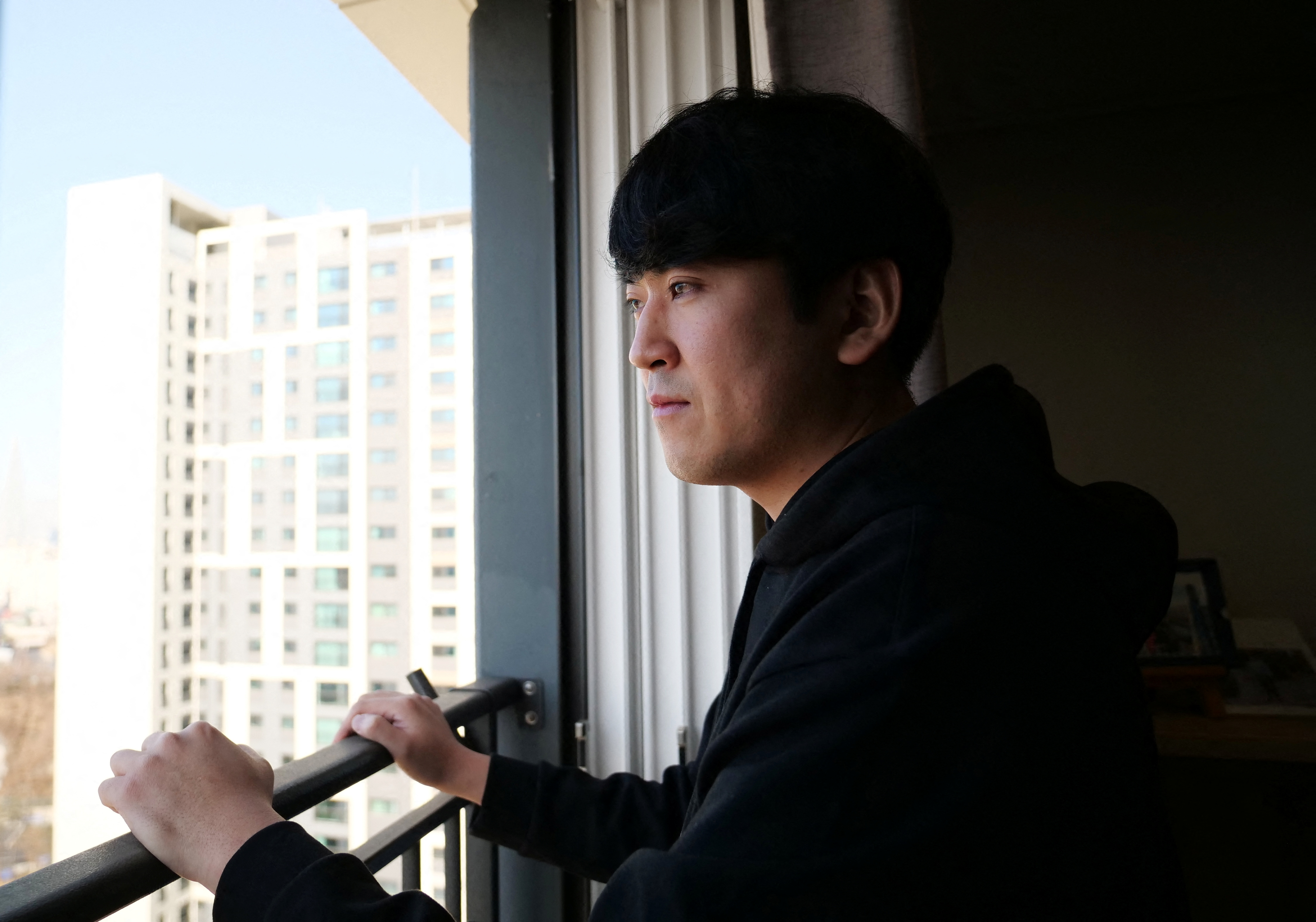 Jang Sung-won, 32, who owns YouTube channel Saver King, looks out from his home in Paju
