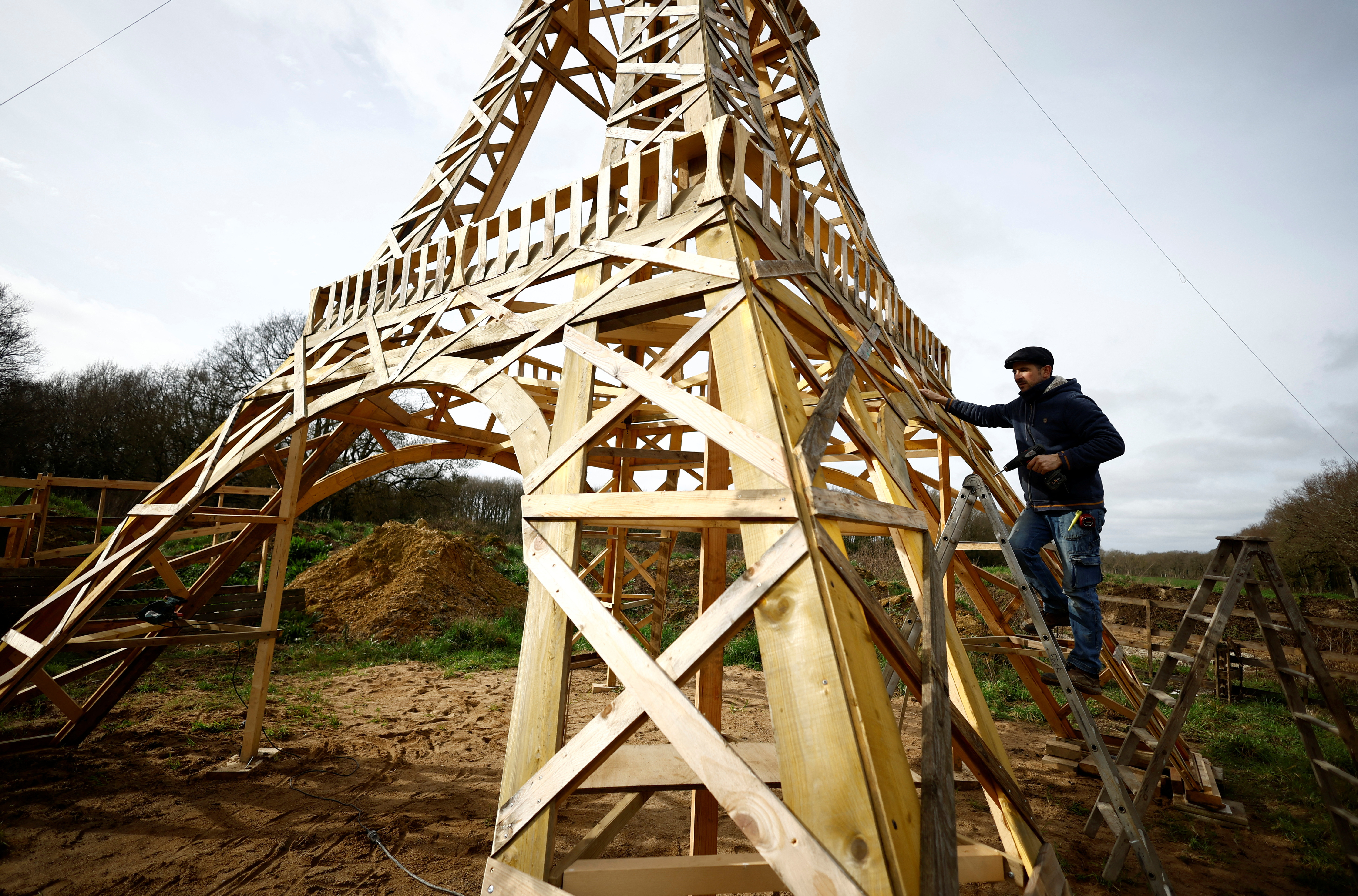 A French carpenter builds a replica of the Eiffel Tower from recycled wood in western France