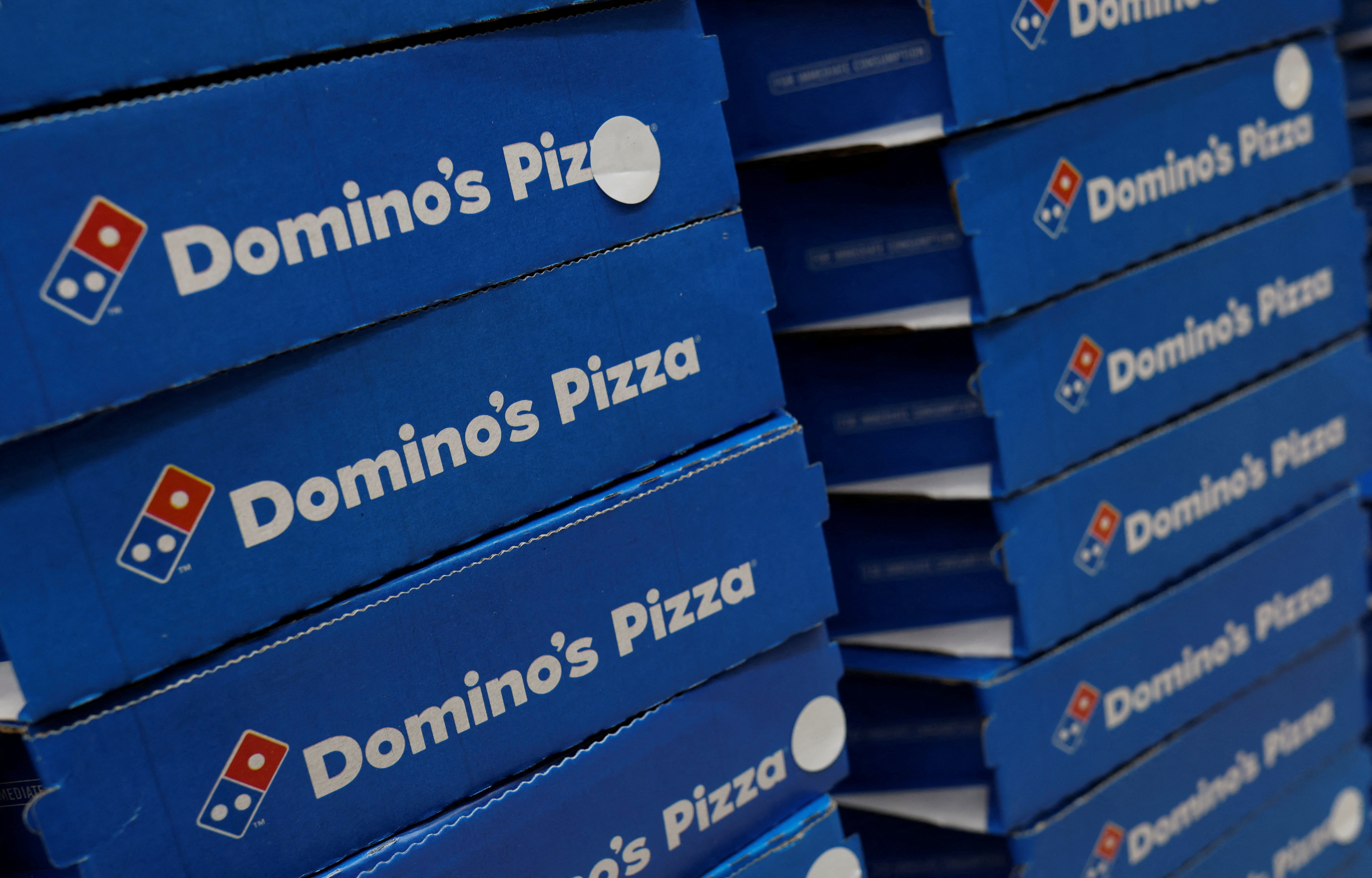 Domino's pizza boxes are pictured inside a restaurant in Noida