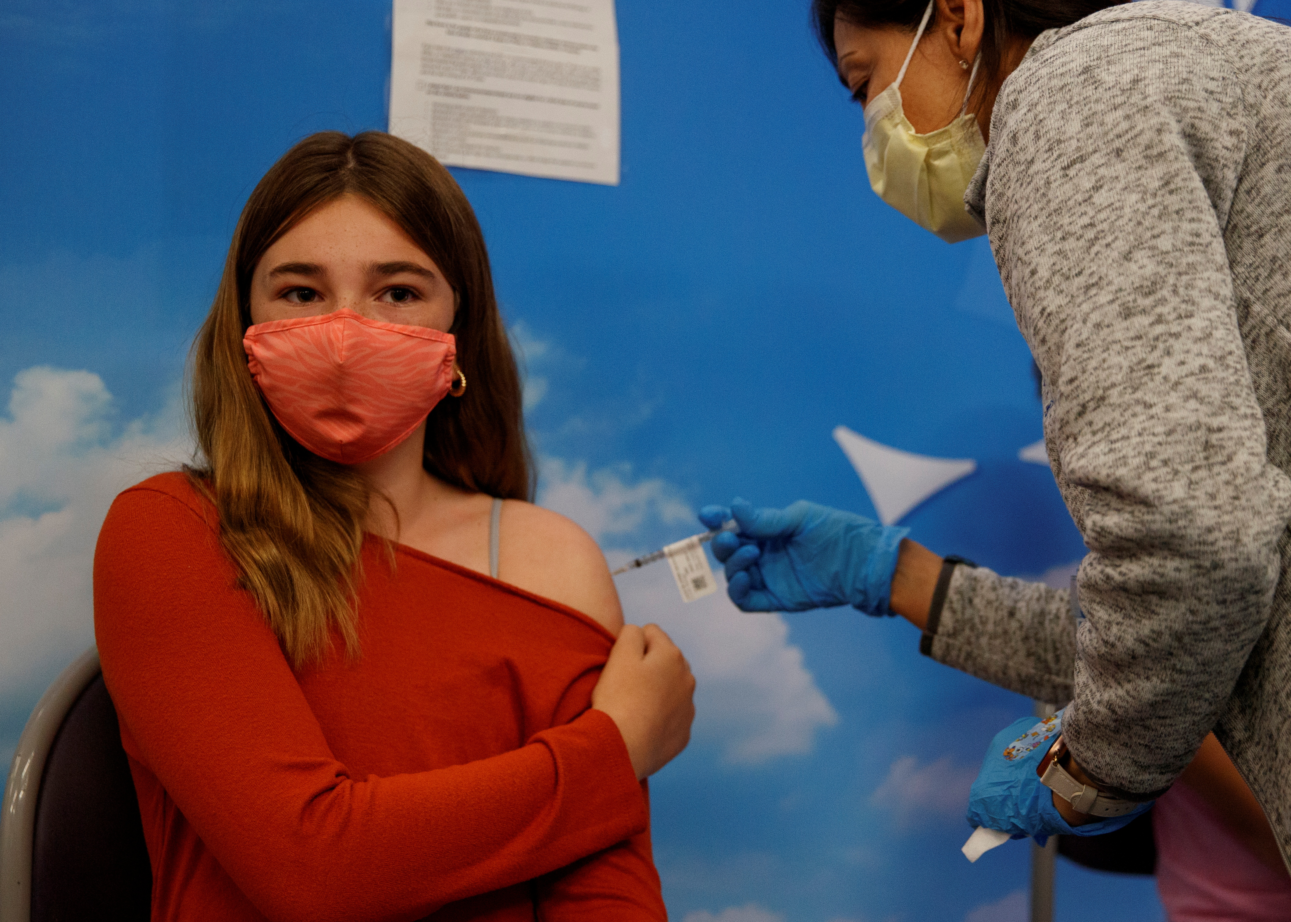 Eleven year-old Victoria Stout receives the Pfizer-BioNTech coronavirus vaccine at Rady's Children's hospital vaccination clinic in San Diego, California, U.S., November 3, 2021.  REUTERS/Mike Blake