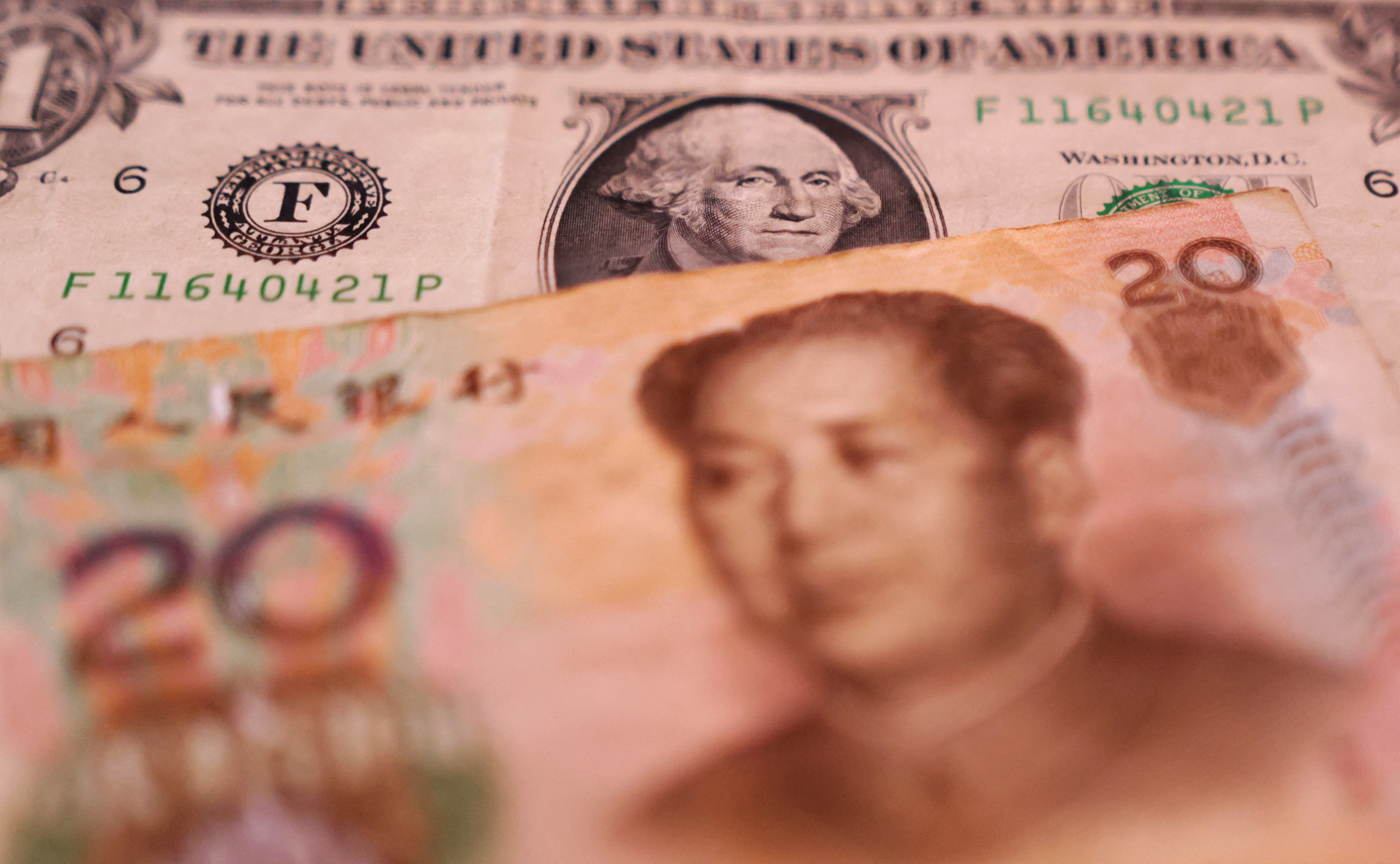 Illustration shows U.S. dollar and Chinese Yuan banknotes