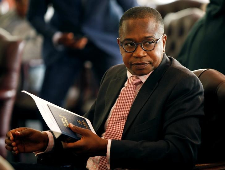 Zimbabwean Finance Minister Mthuli Ncube looks on before the swearing in of new cabinet ministers at State House in Harare