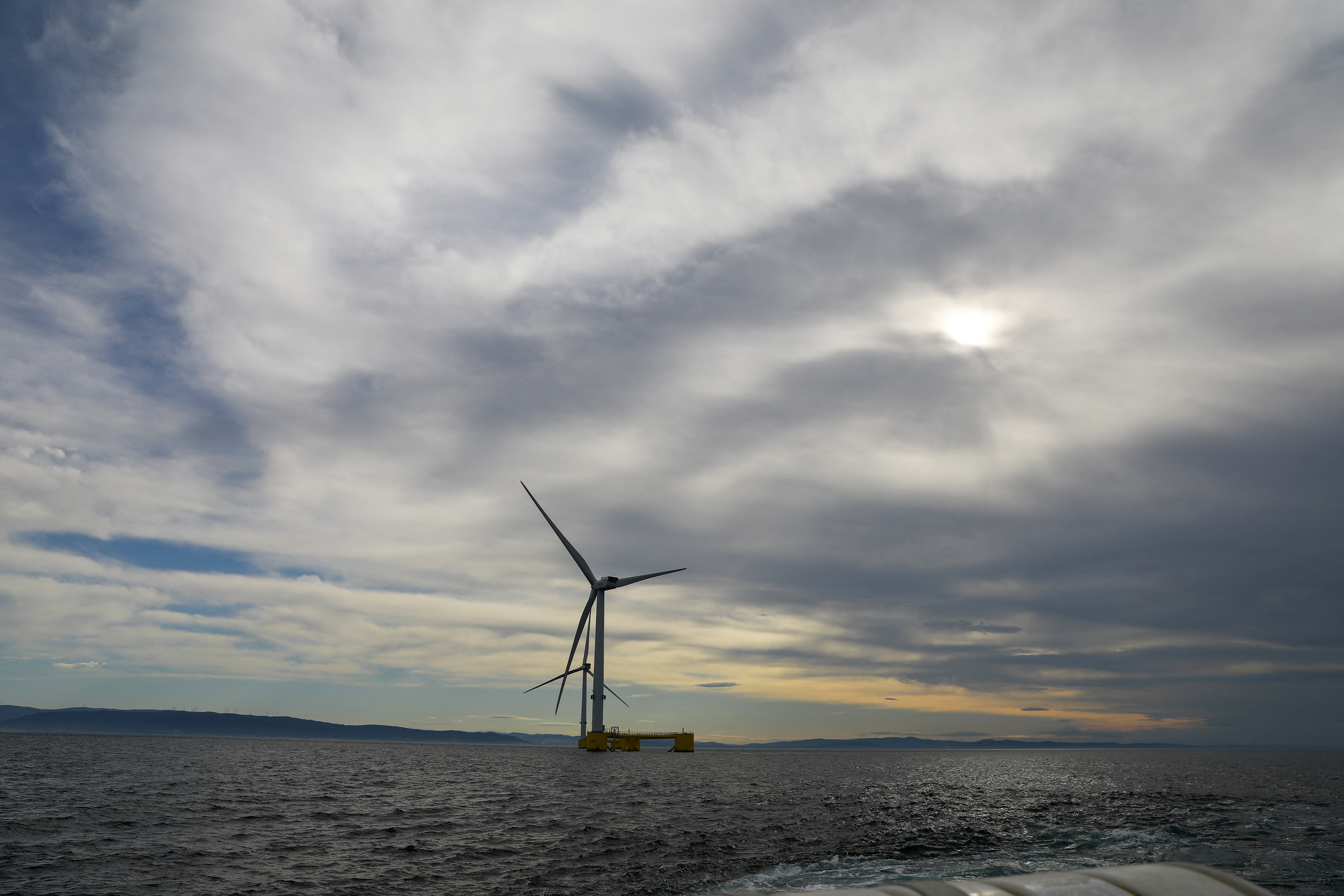 Turbines of the WindFloat Atlantic Project, a floating offshore wind-power generating platform, are seen 20 kilometers off the coast in Viana do Castelo