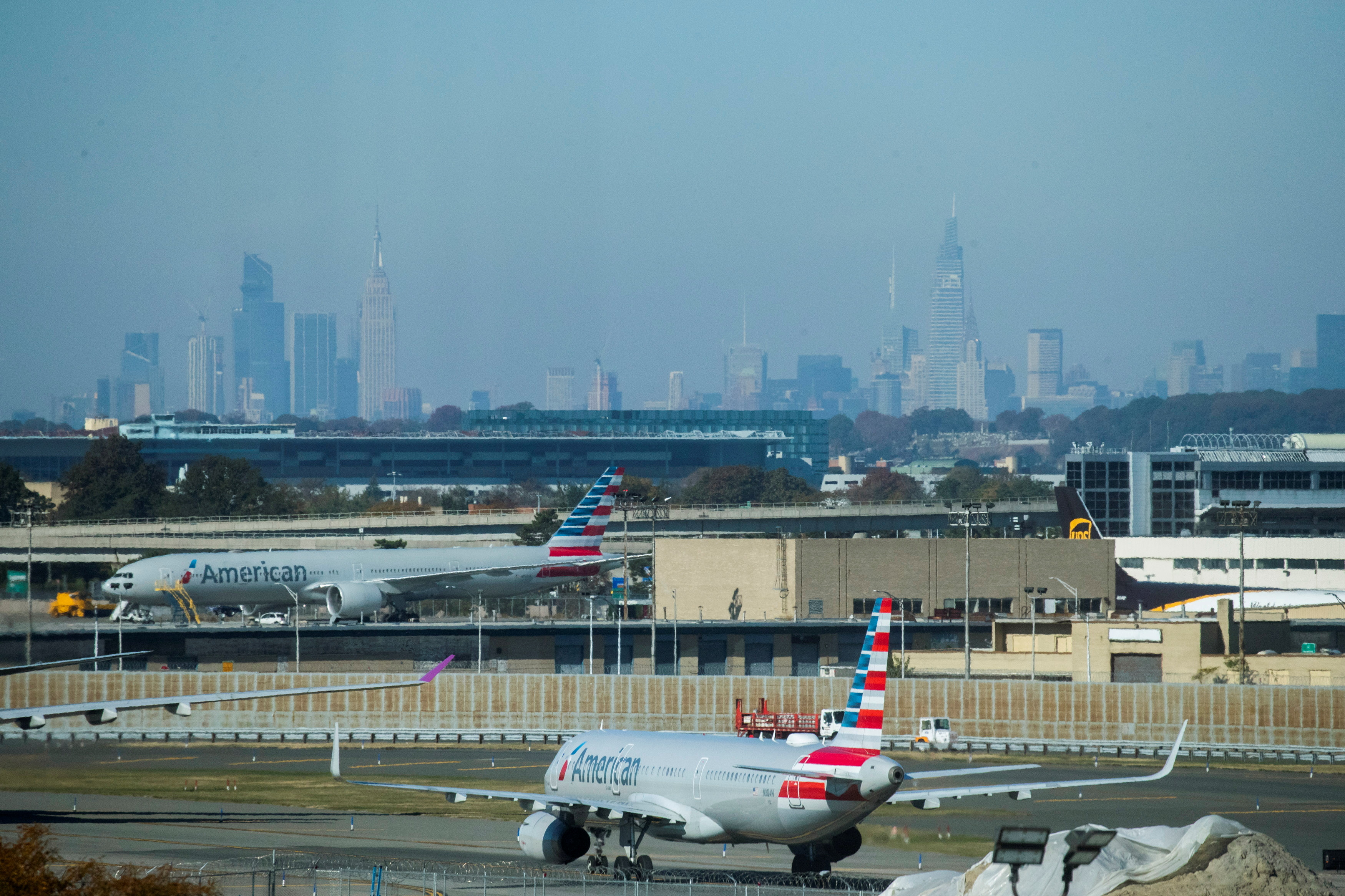 American Airlines planes taxi on the tarmac as the skyline of New York City is seen in the background from the JFK International Airport in New York, U.S.,  November 8, 2021. REUTERS/Eduardo Munoz/File Photo