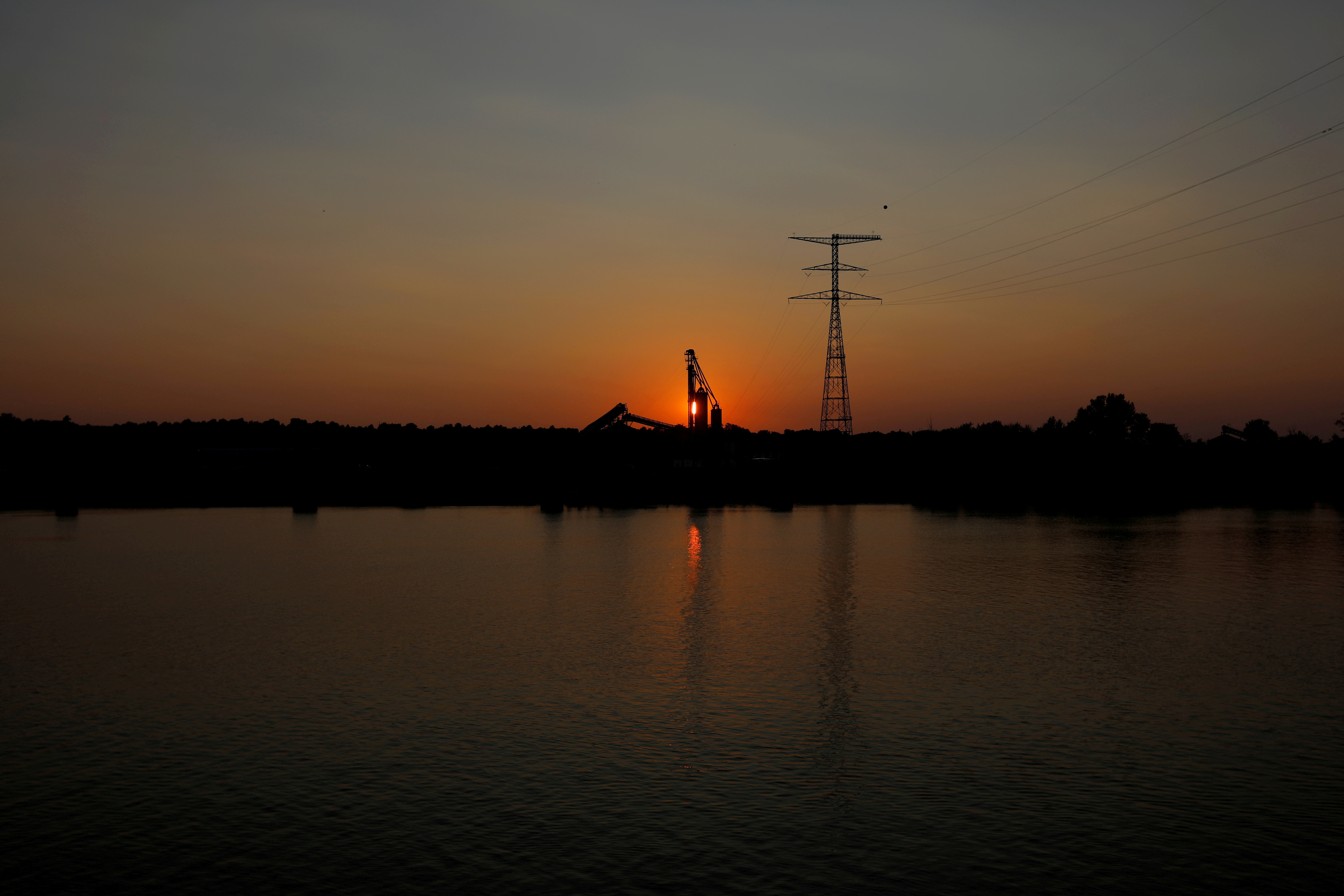 FILE PHOTO: The sun sets behind grain elevators at the Bunge Grain facility along the Ohio River in Owensboro
