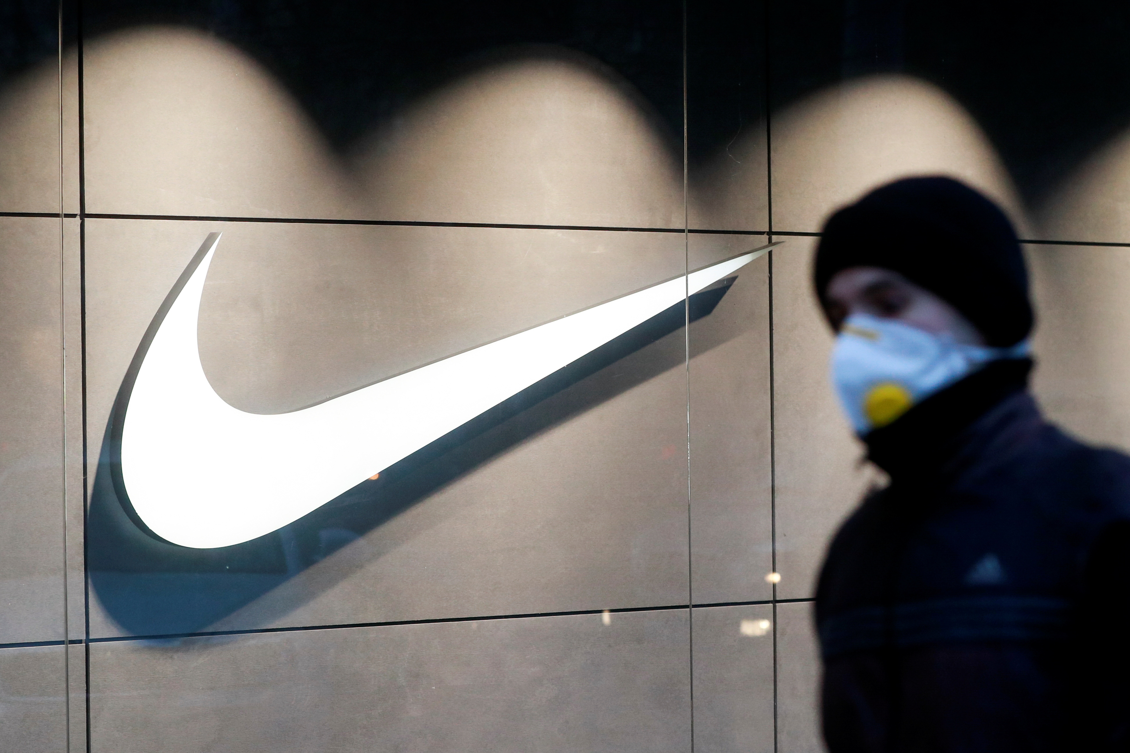 A man walks past a Nike brand store in Kyiv