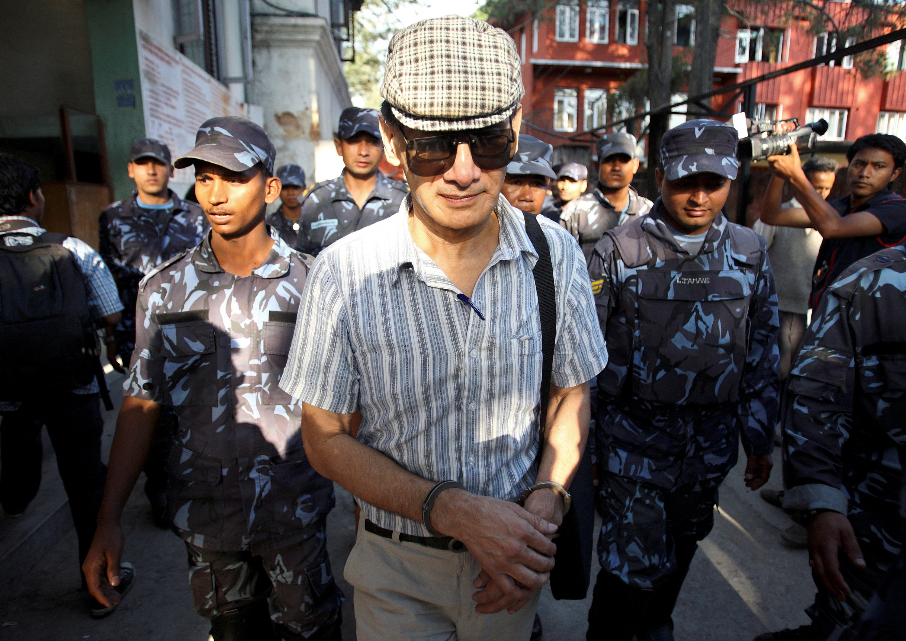 French serial killer Charles Sobhraj leaves Kathmandu district court after his hearing in Kathmandu