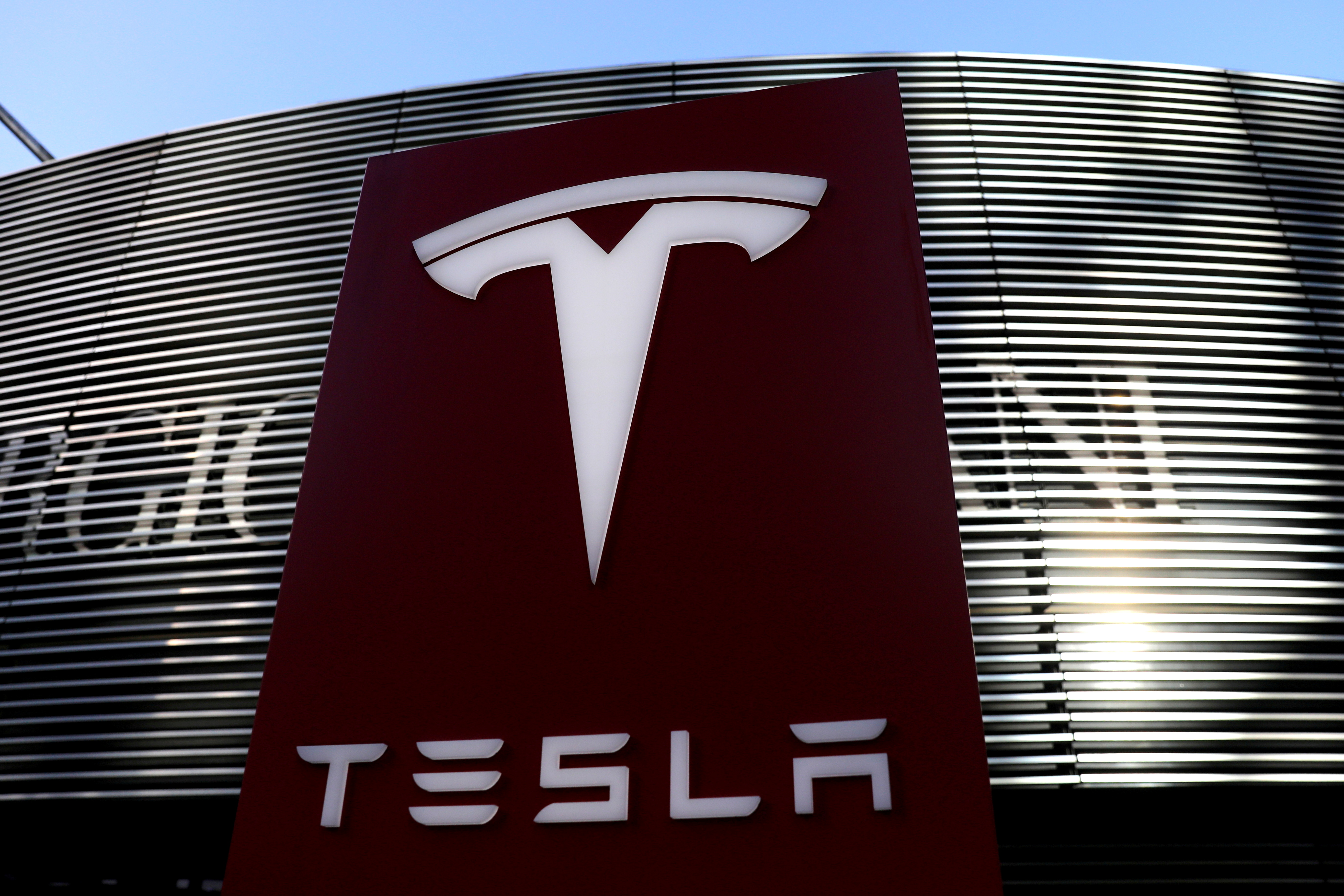 A logo of the electric vehicle maker Tesla is seen near a shopping complex in Beijing, China January 5, 2021. REUTERS/Tingshu Wang