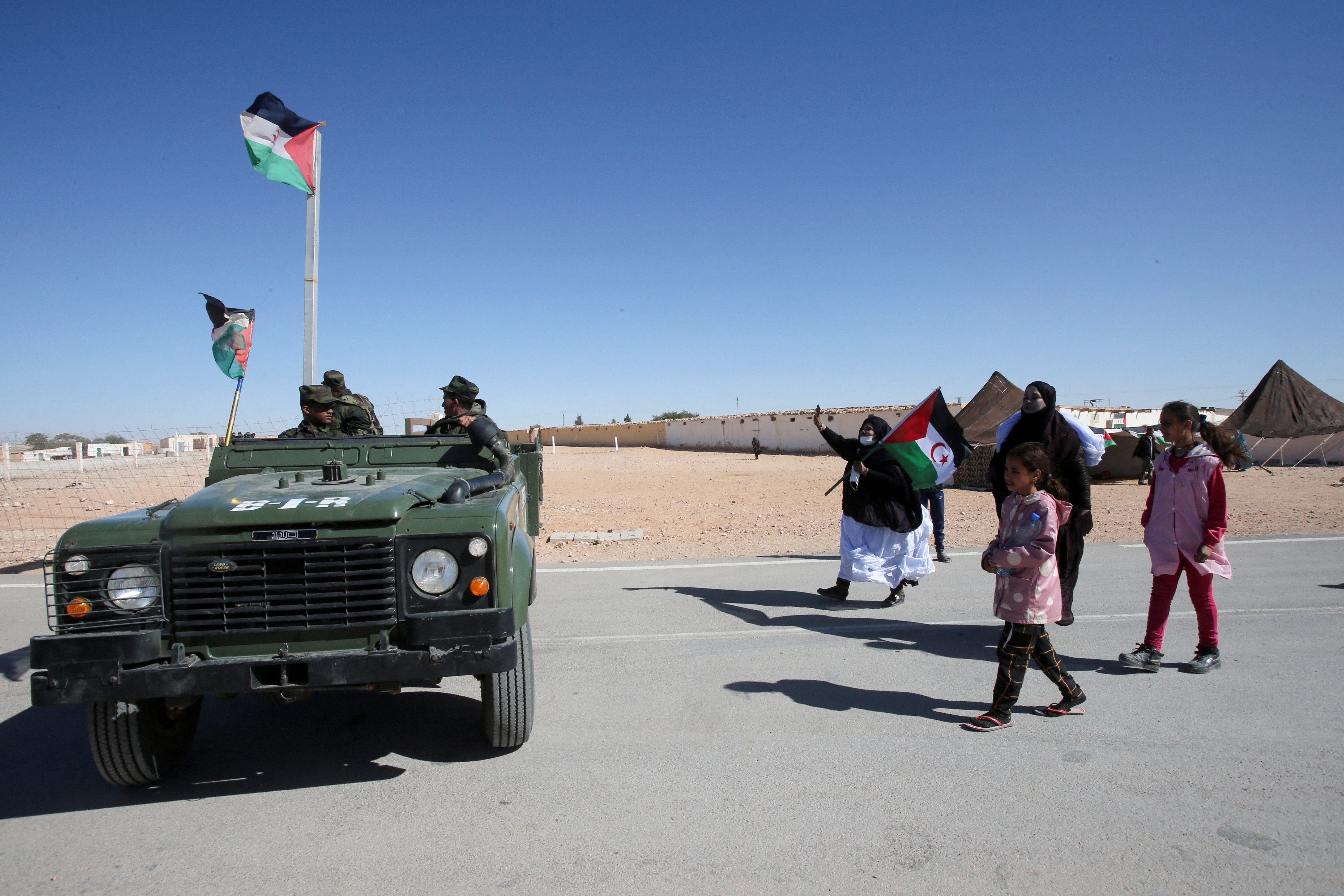 People greet Sahrawi soldiers during the visit of U.N. envoy to Western Sahara Staffan de Mistura to a refugee camp in Tindouf