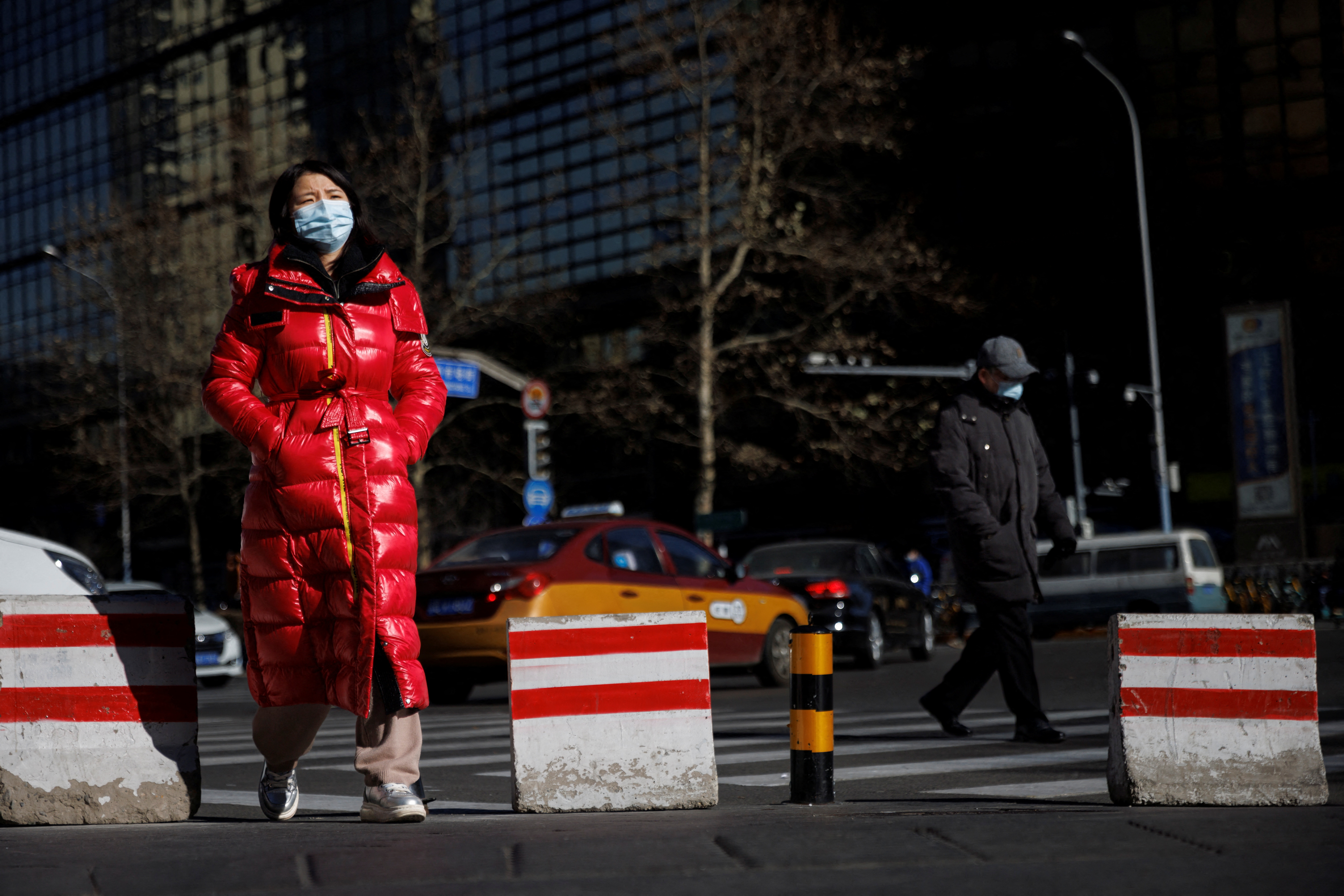 People walk on a street as the coronavirus disease (COVID-19) outbreak continues in Beijing