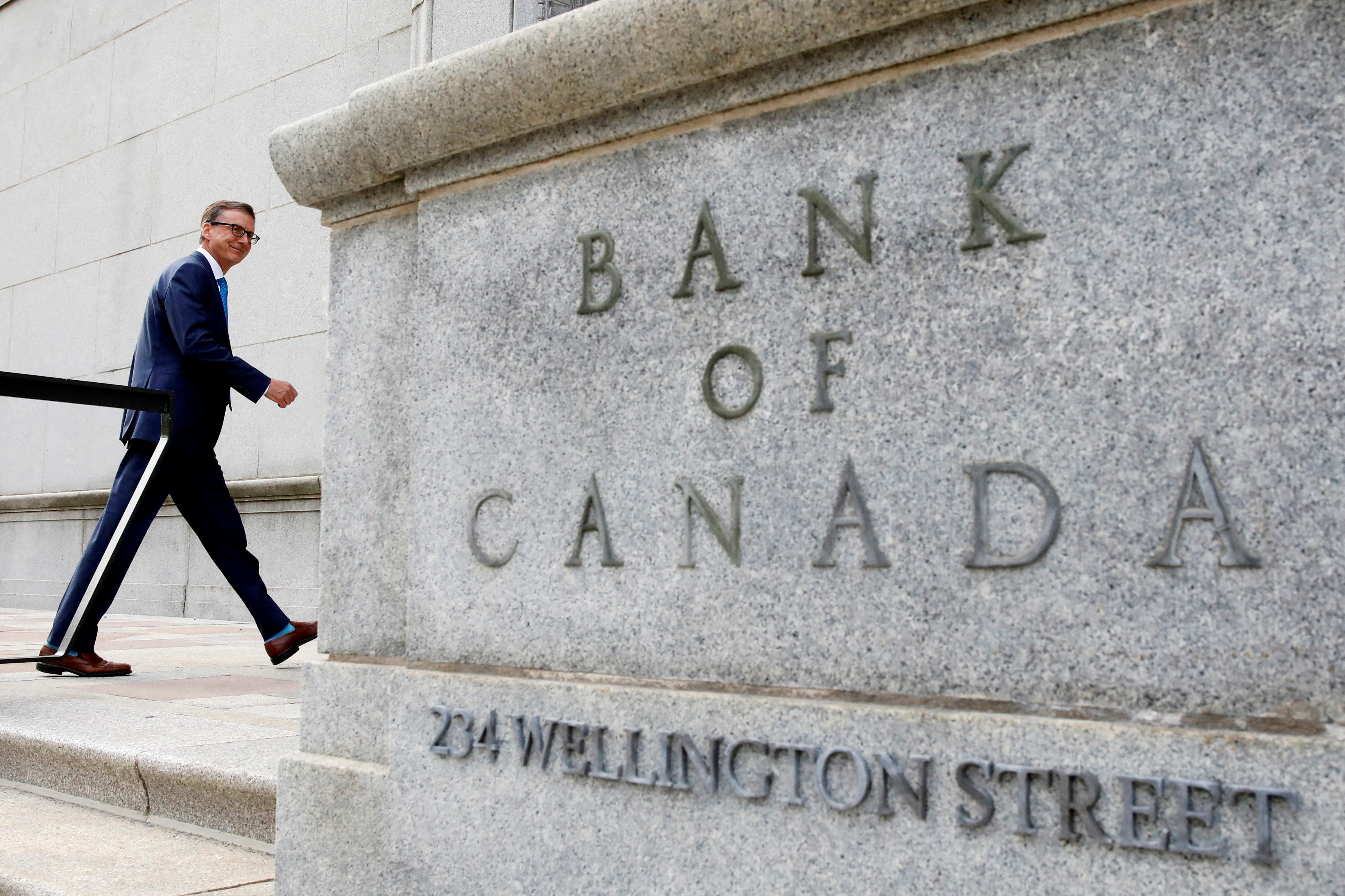 Bank of Canada Governor Tiff Macklem walks outside the Bank of Canada building in Ottawa